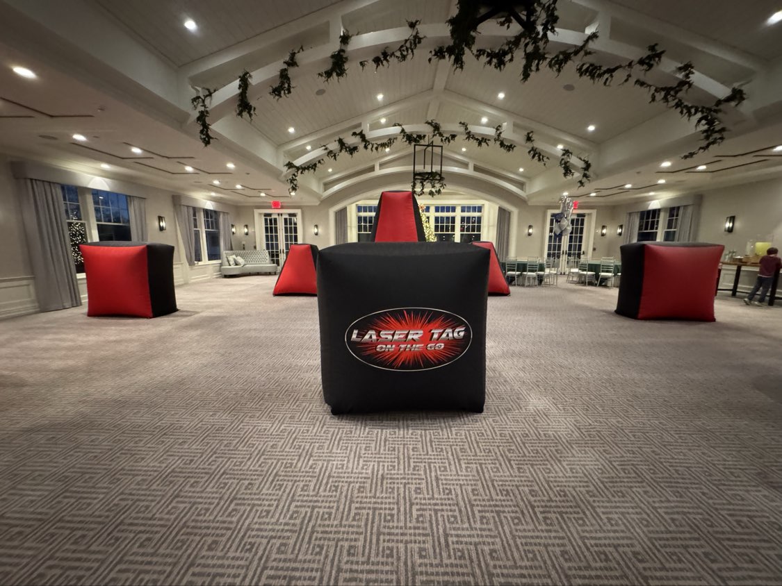Laser Tag On The Go Setup — indoor hall setup with red, blue and black inflatable bunkers