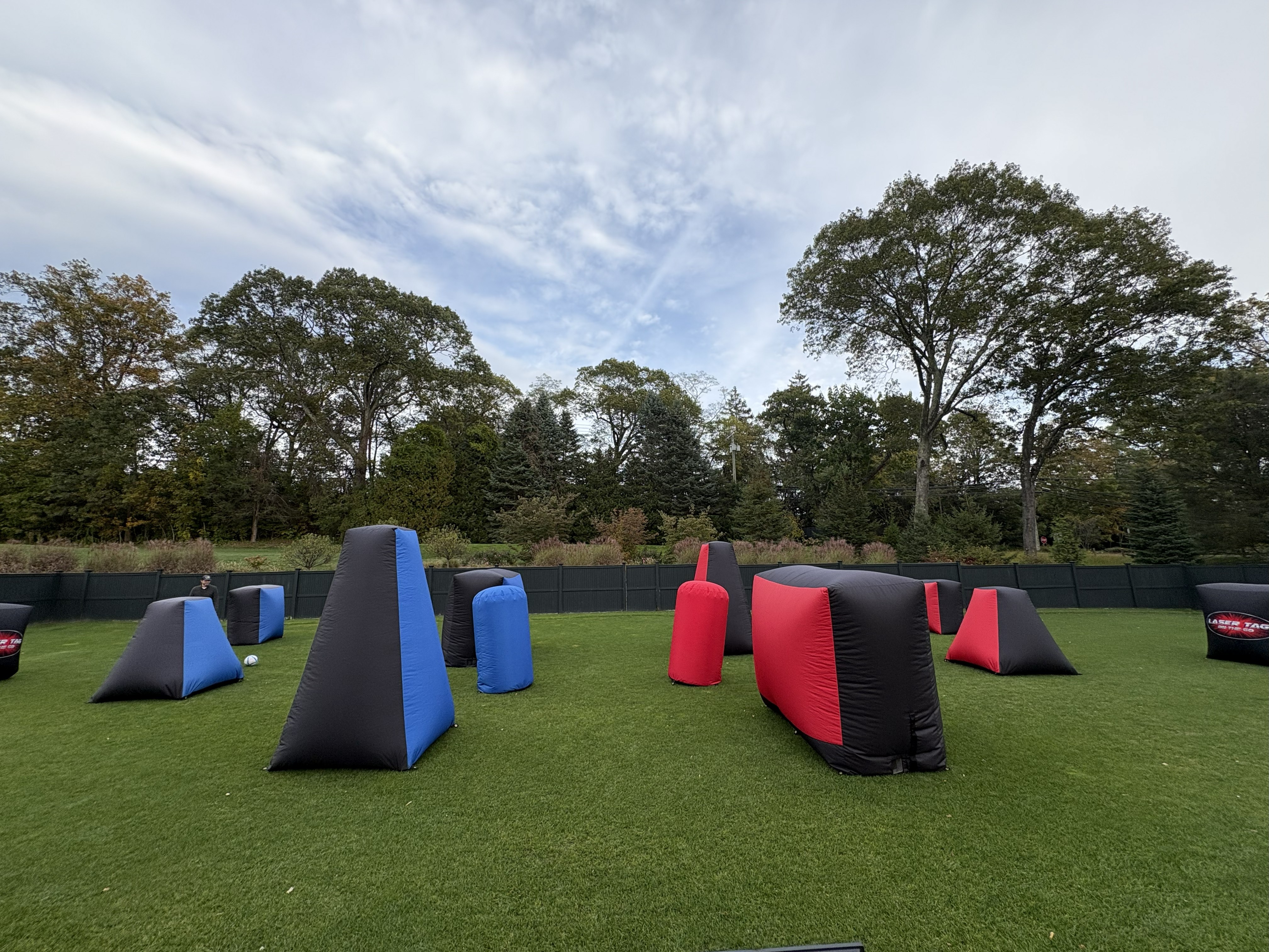 Inflatable Bunkers — mobile laser tag arena with red, blue and black inflatable bunkers on turf field