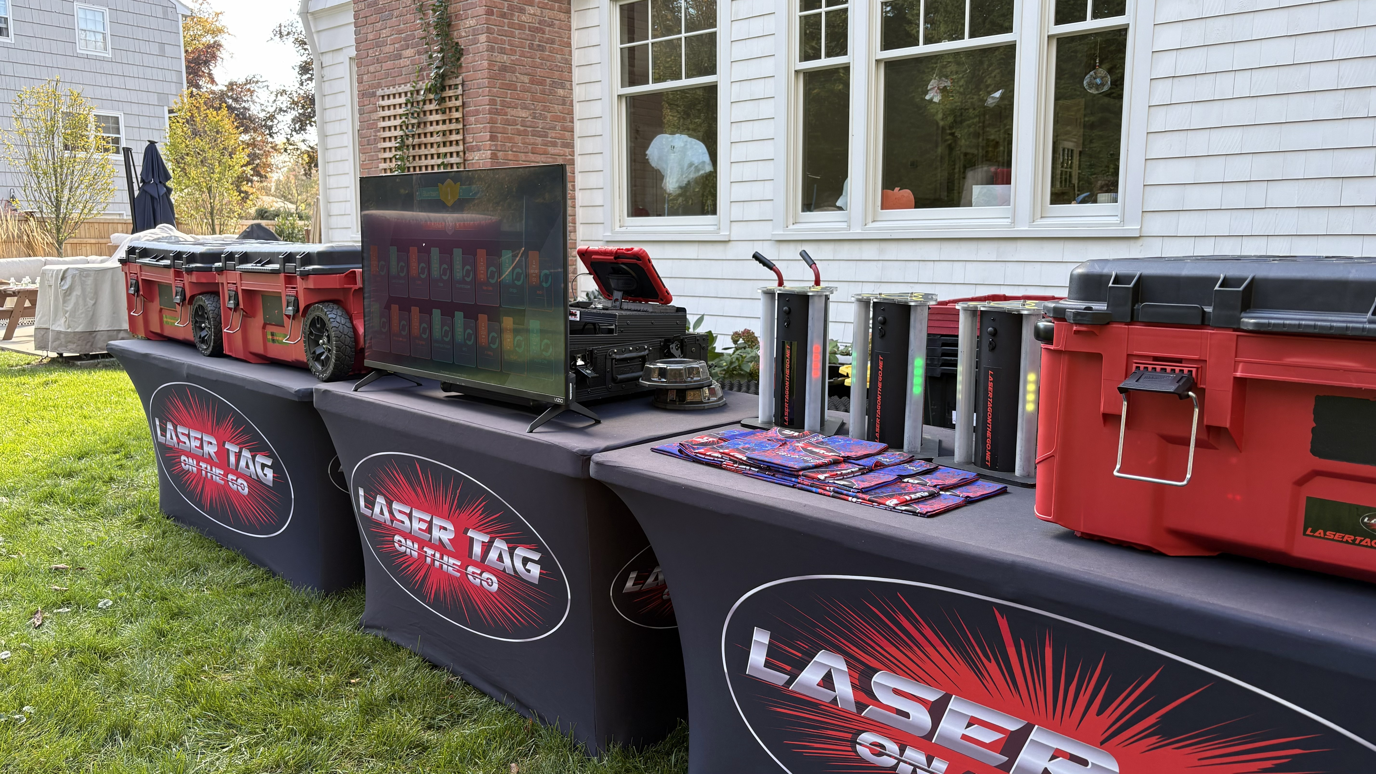 Laser Tag On The Go Setup — branded equipment tables with digital scoreboard screen, game cases and accessories