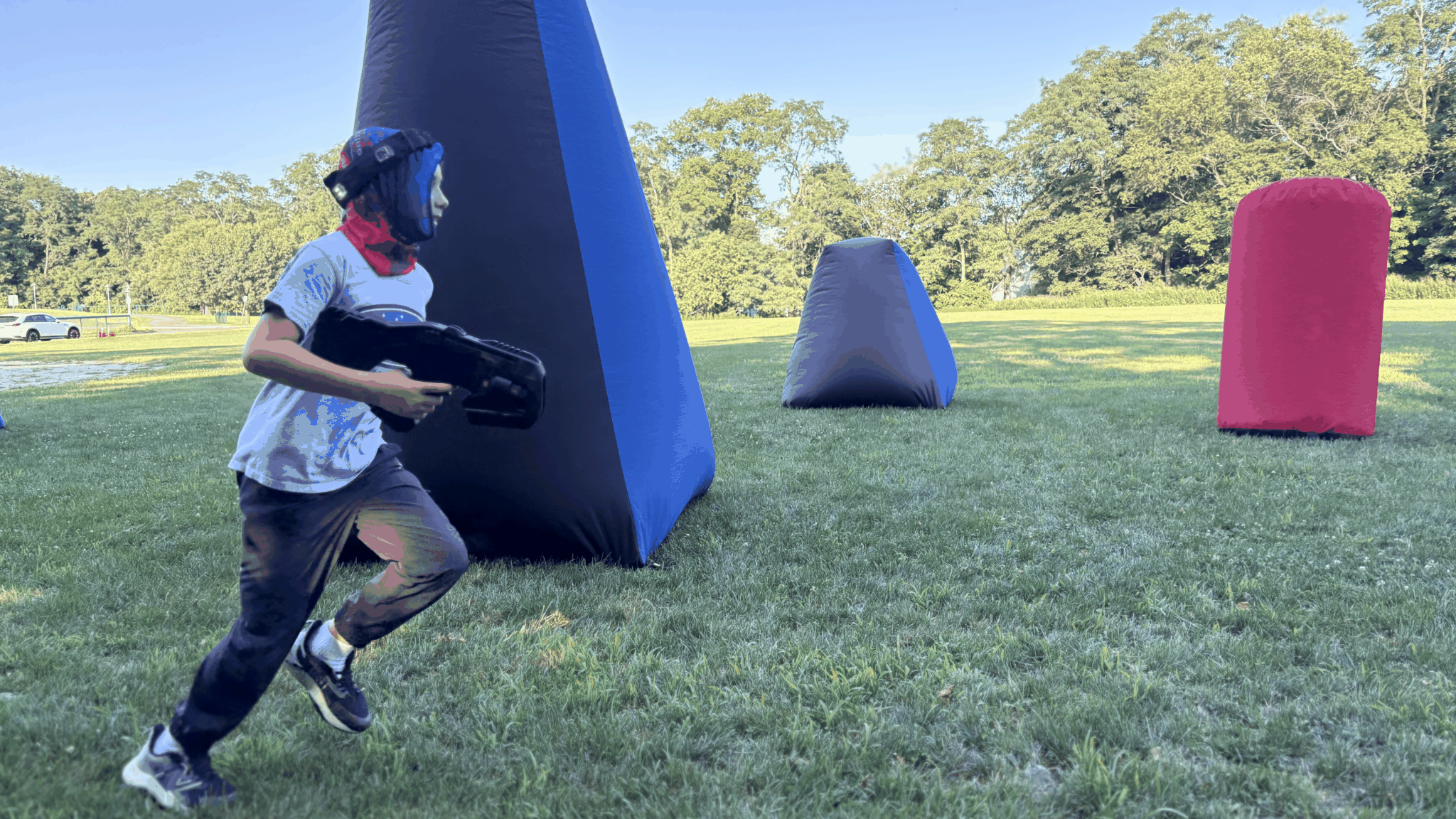 Young player running past inflatable bunkers during a Laser Tag On The Go birthday party game