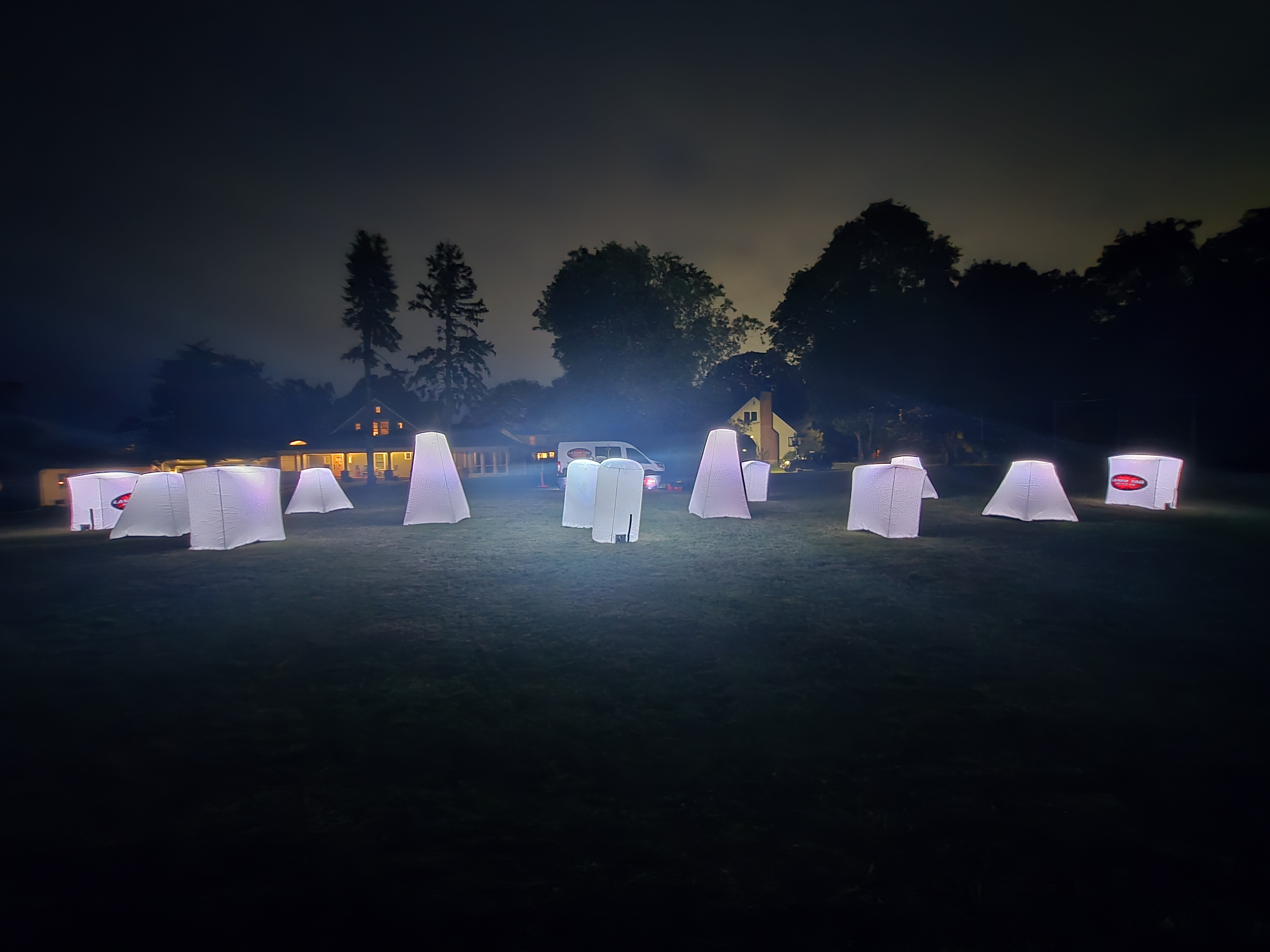 Outdoor Glow Course — wide field view of glowing white bunkers at night