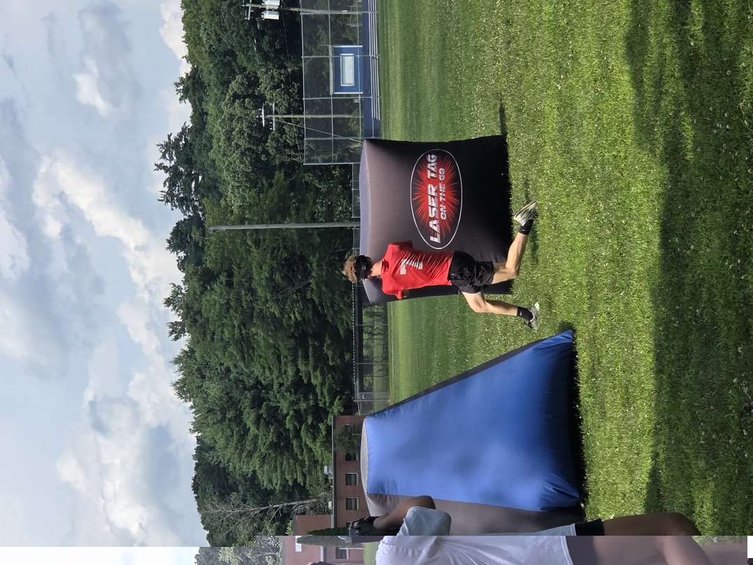 Camp player maneuvering around an official Laser Tag On The Go branded inflatable bunker
