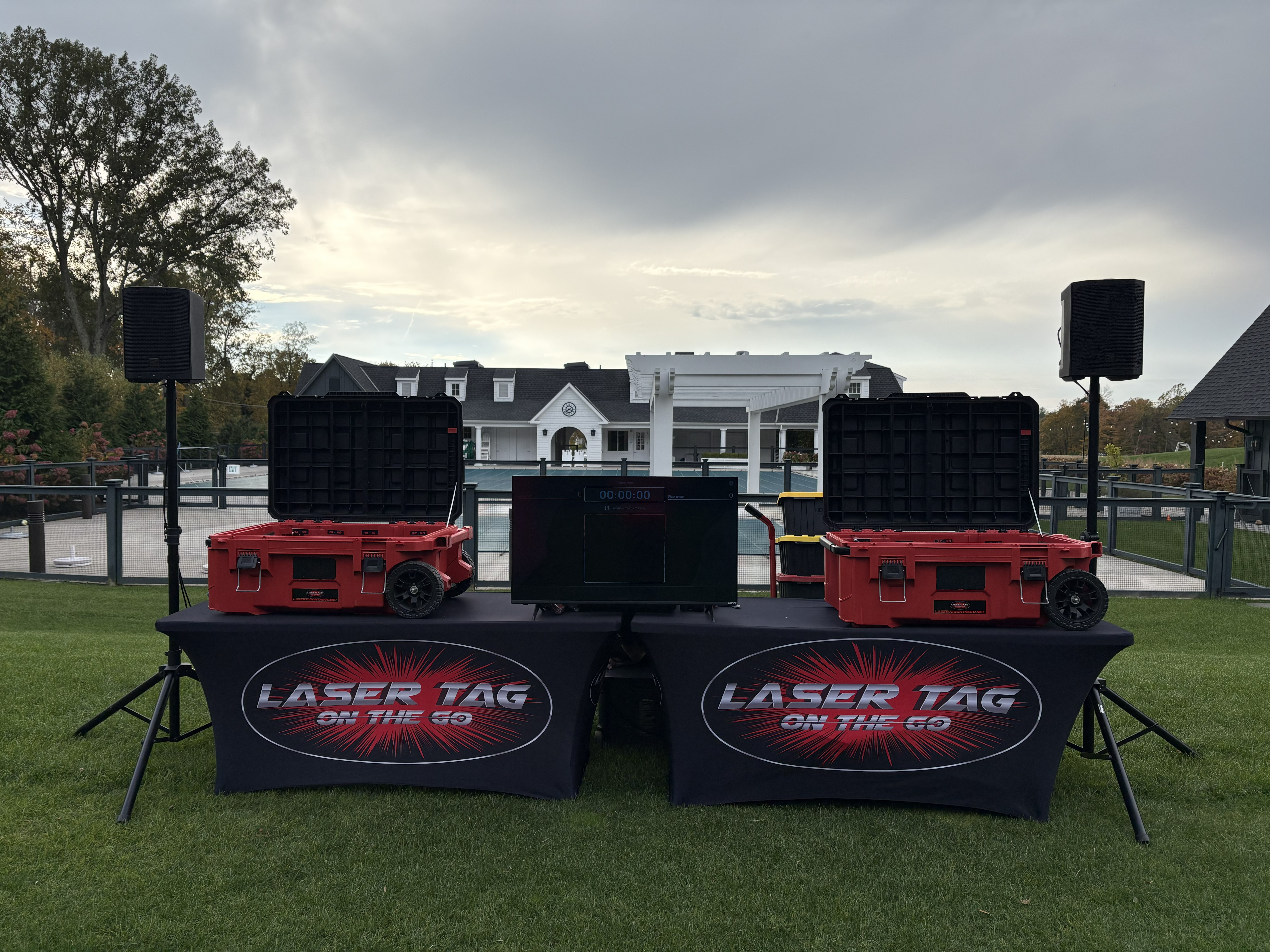 Laser Tag On The Go Setup — event audio sound system and equipment cases on branded display tables