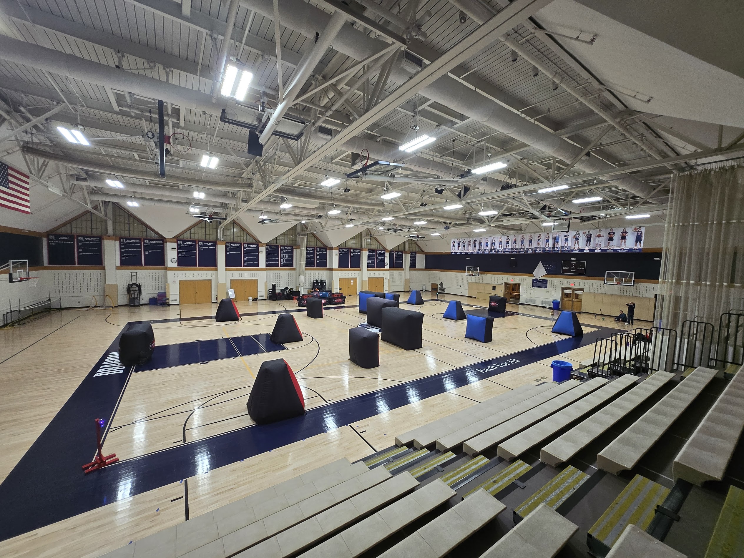 Full school gymnasium laser tag setup with inflatable bunkers and Game Field Boxes