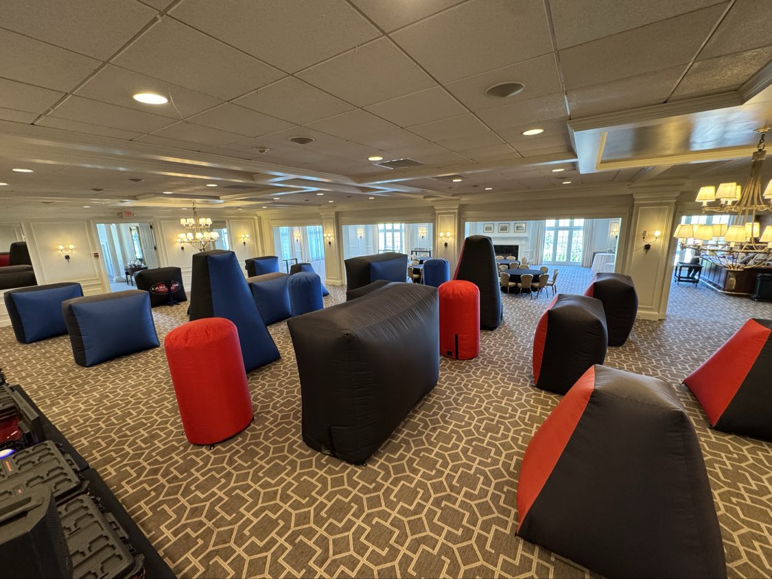 Inflatable Bunkers — wide view of indoor ballroom arena with red and blue inflatable obstacles