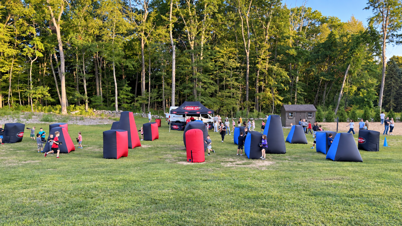 Outdoor school laser tag event with inflatable bunkers, players and open field arena