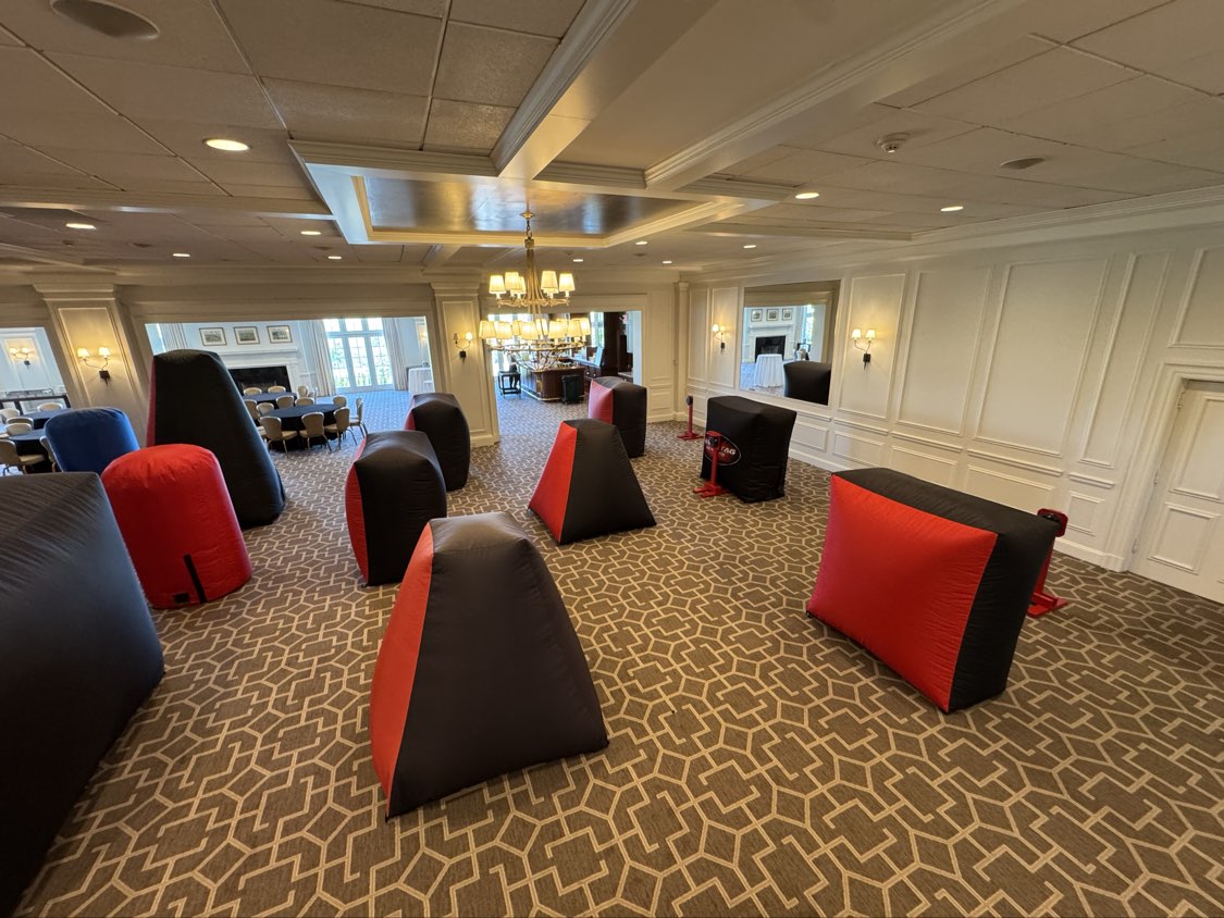 Inflatable Bunkers — indoor ballroom laser tag arena setup with red and black inflatable bunkers and target stations