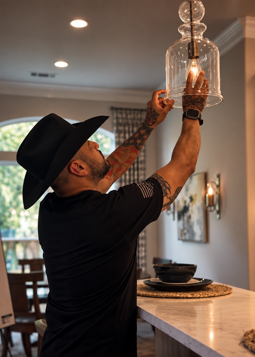 Luis Aguilar inspecting an interior glass pendant light fixture during a residential property evaluation in The Woodlands, Texas