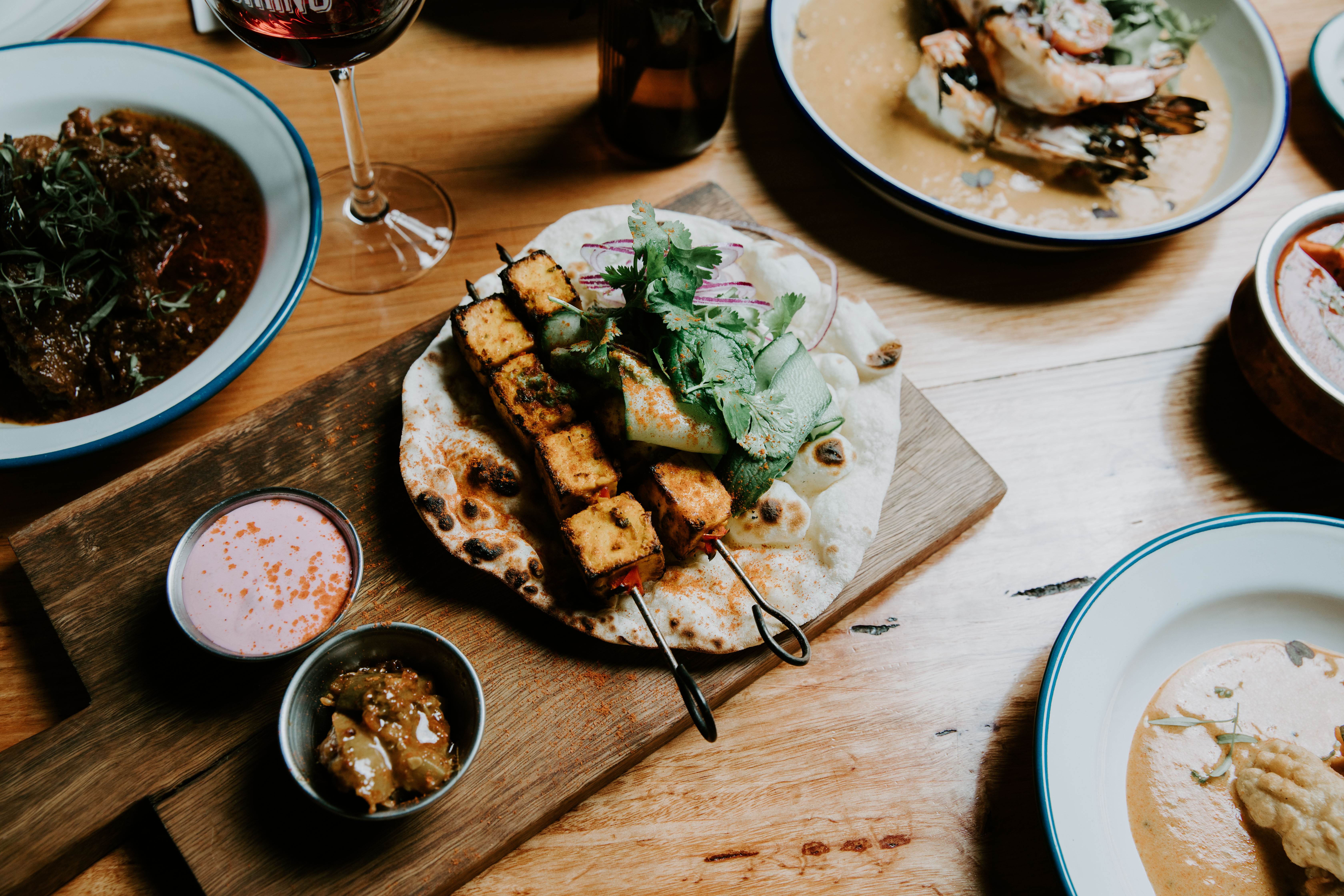 Authentic regional Indian charcoal skewers and dishes on wood board