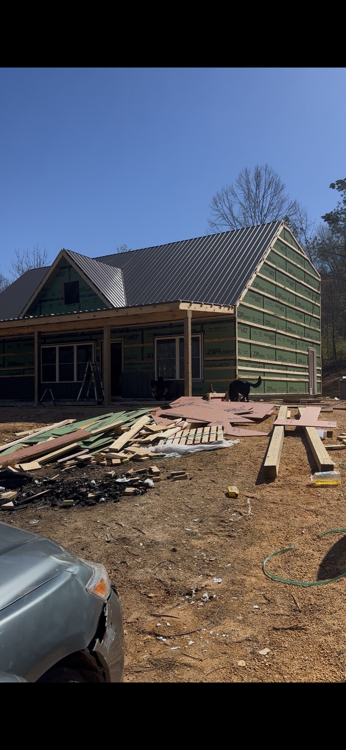 Joel Lindberg Residence — Finished standing seam metal roof, framed dormer, and porch assembly in progress