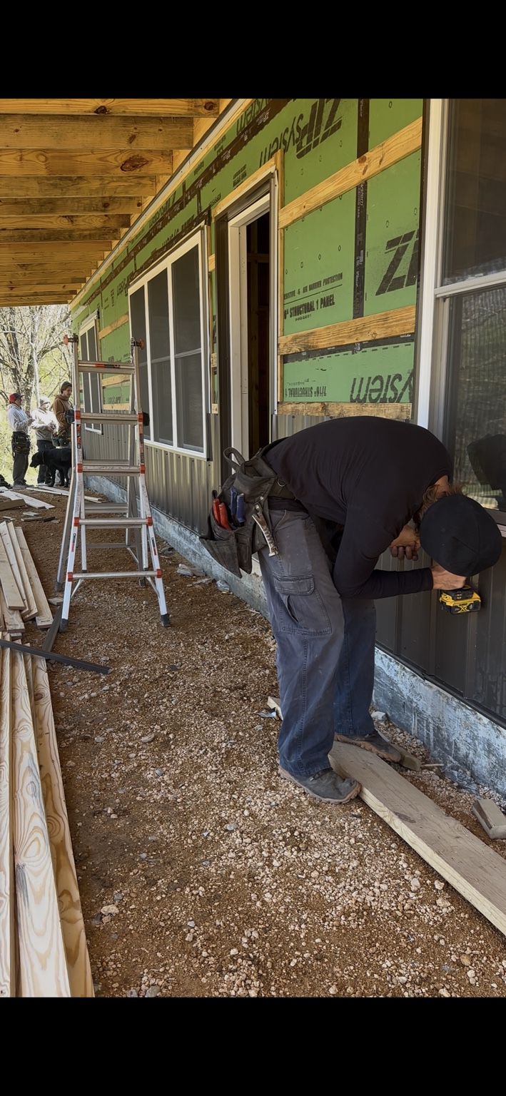 Joel Lindberg Residence — Fastening metal wainscot siding along the porch elevation with crew on site