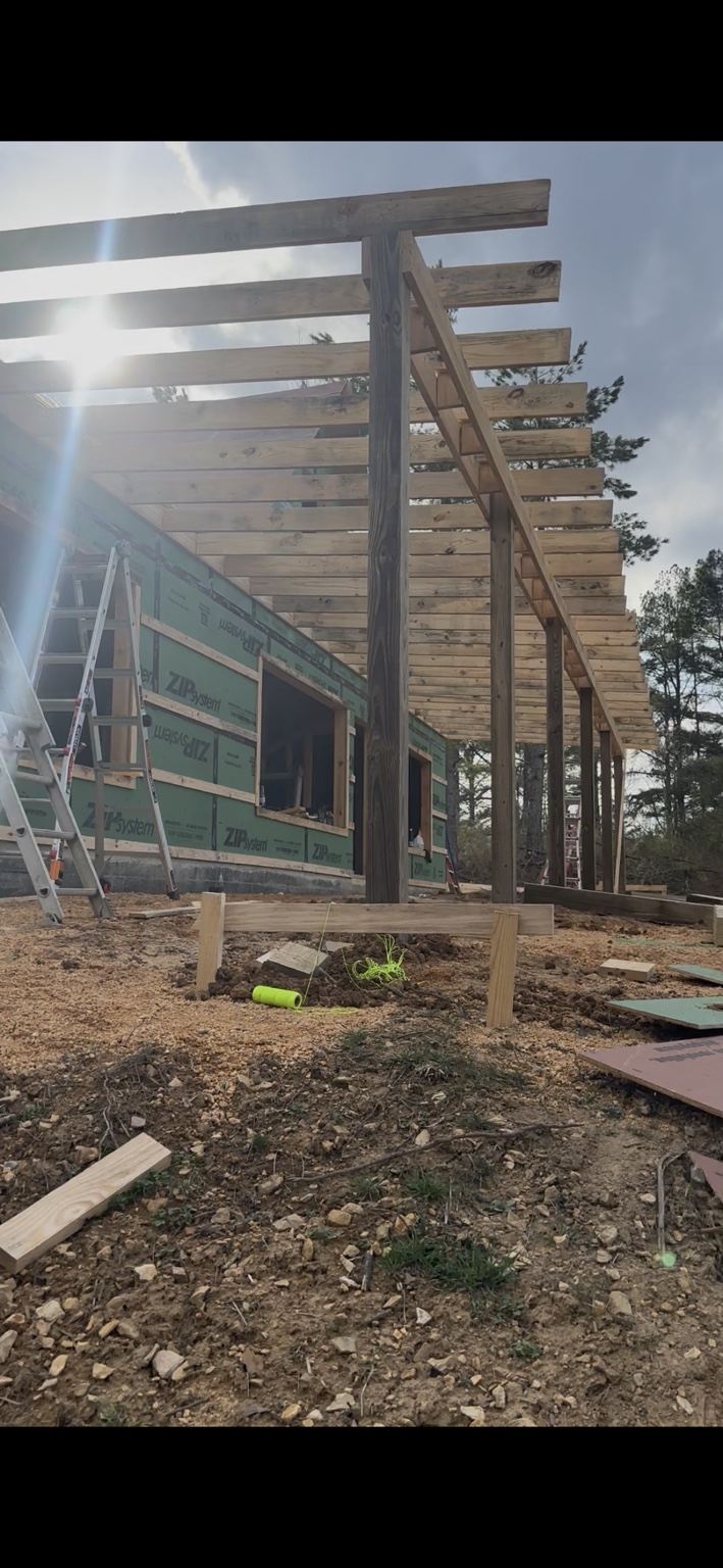 Joel Lindberg Residence — Timber porch rafter framing with structural support posts and stringline grading