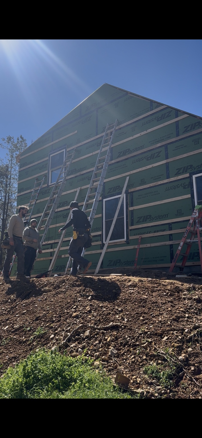 Joel Lindberg Residence — Crew installing horizontal wall strapping over Zip System barrier on gable end