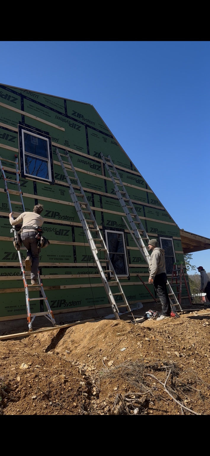 Joel Lindberg Residence — Brotherhood crew securing upper gable wall strapping from extension ladders