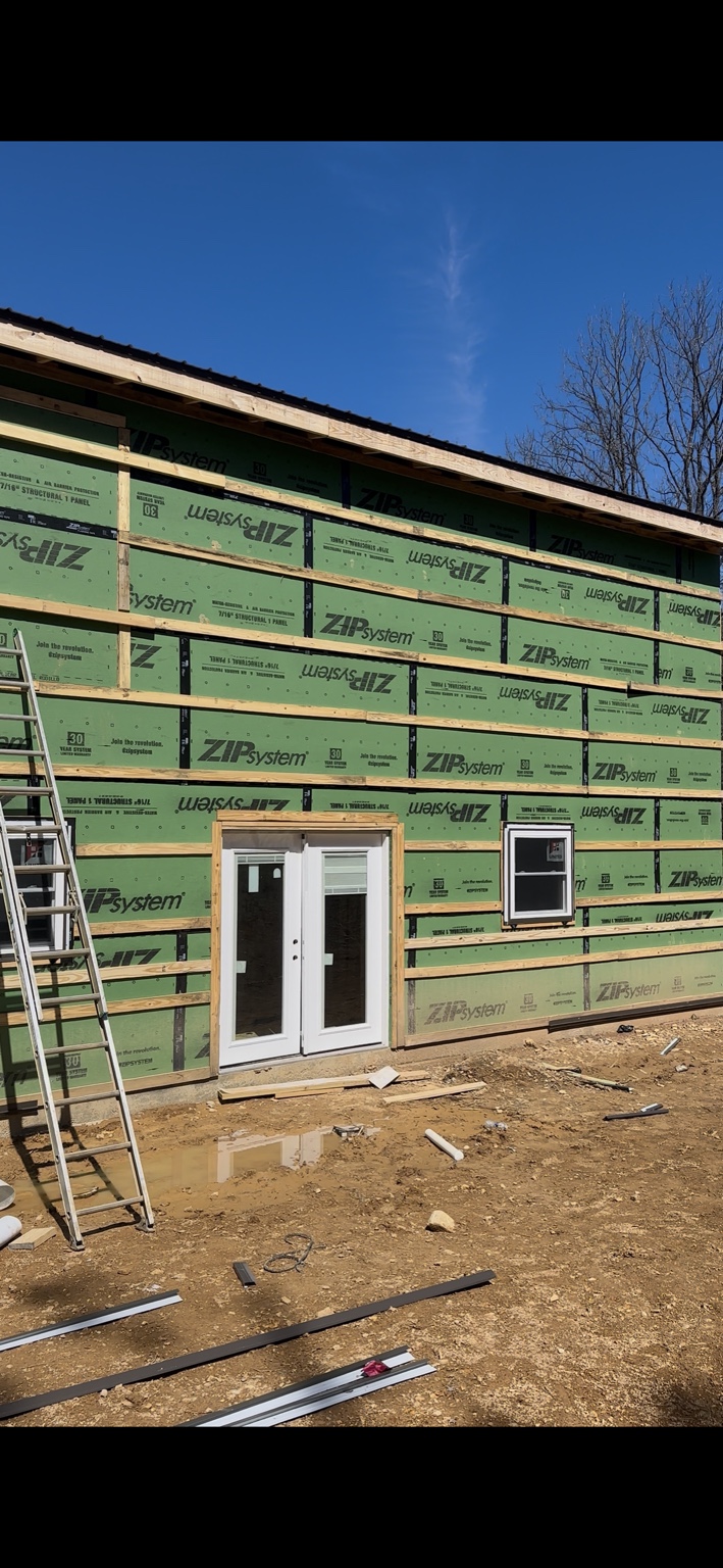Joel Lindberg Residence — Rear exterior elevation with French doors, taped Zip System sheathing, and siding furring