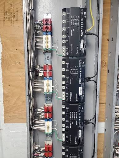 Control4 centralized panelized lighting enclosure with DIN rail modules and terminal blocks