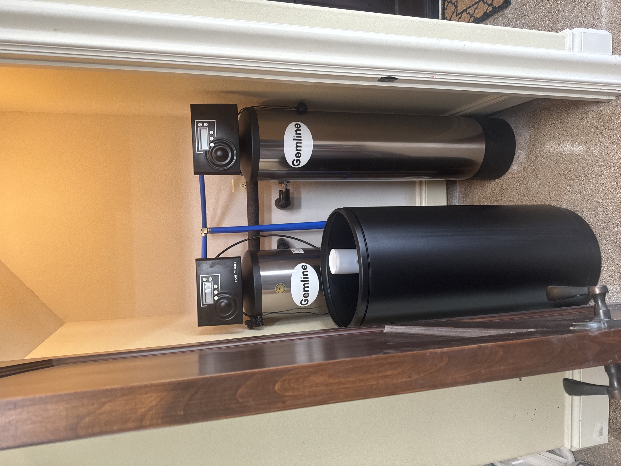 Gemline whole-home water softener and dual media filtration system installed in residential utility closet with brine tank