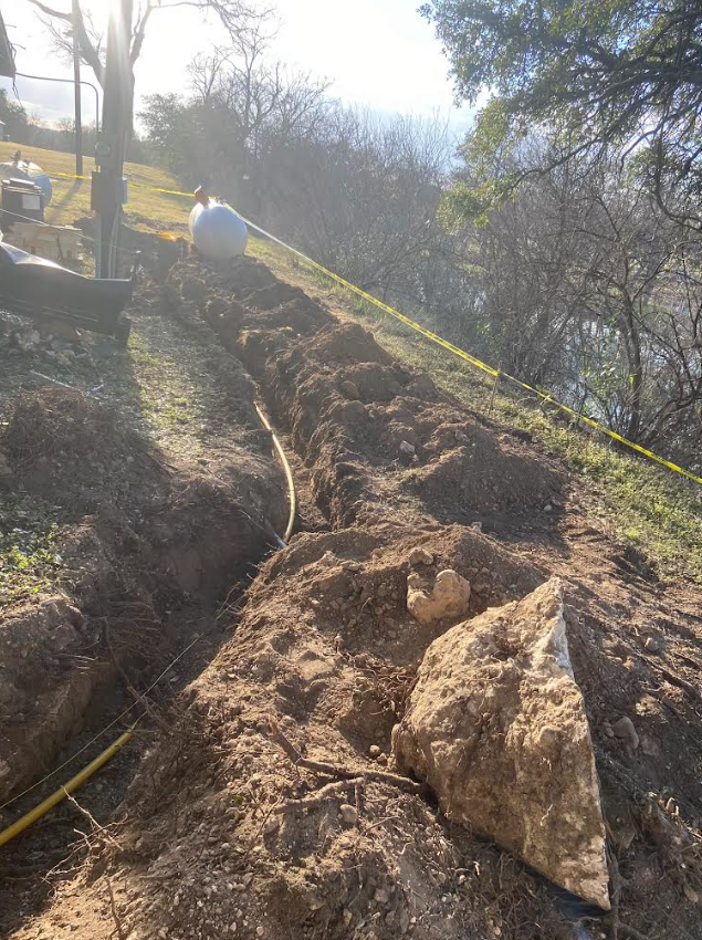 Long trench run with underground gas pipe laid out across property grade