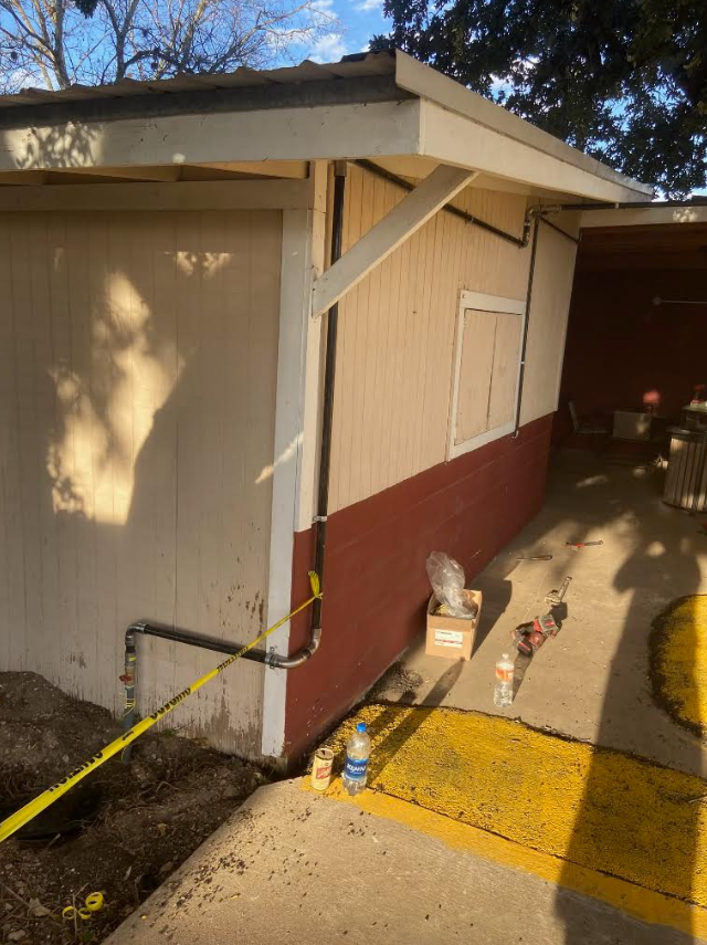 Exterior gas piping cleanly run and strapped along structure wall with shut-off valve