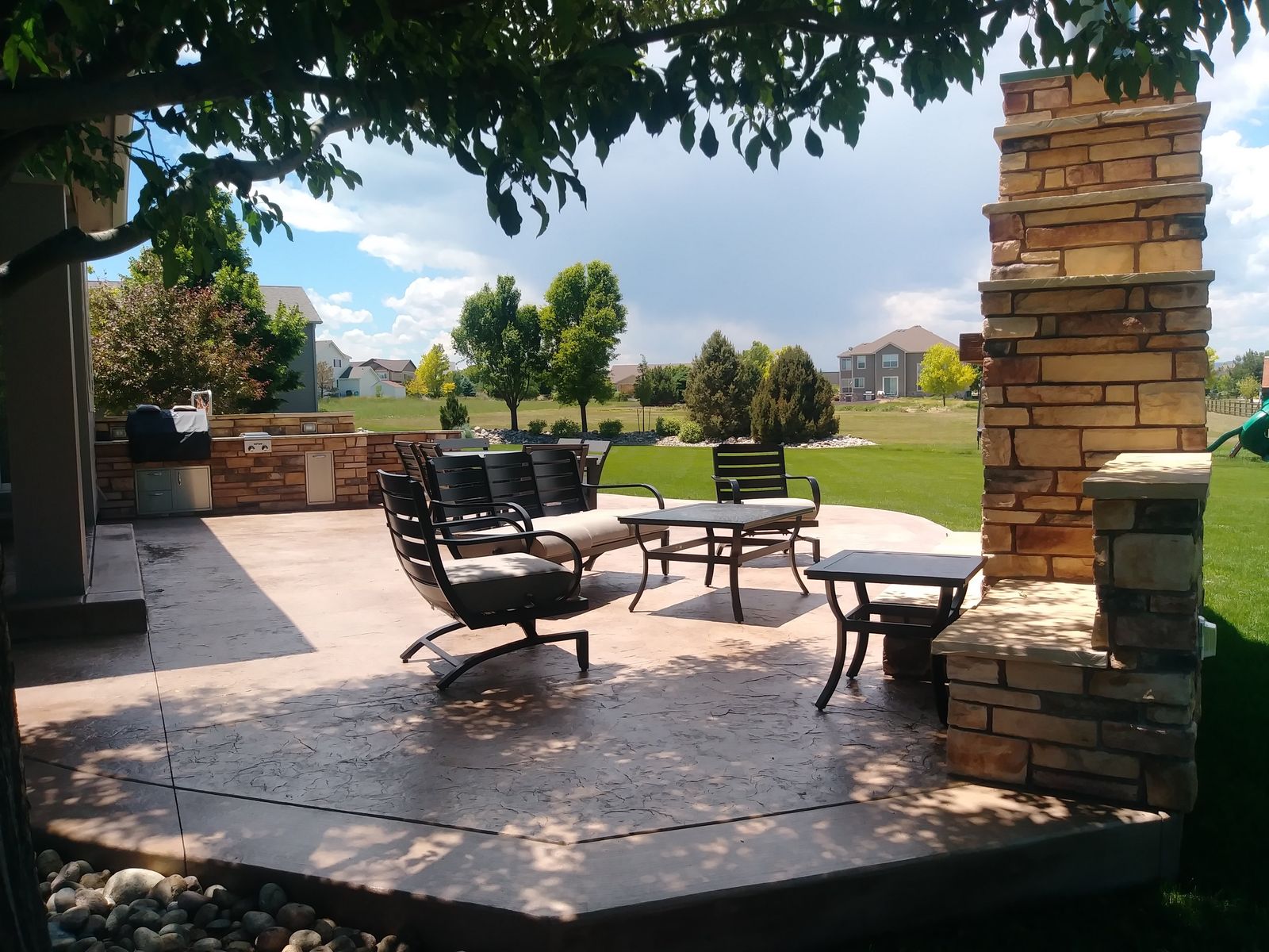 Luxury Stamped Concrete Patio with Outdoor Fireplace & Kitchen Lounge in Frisco TX by Happy's Concrete