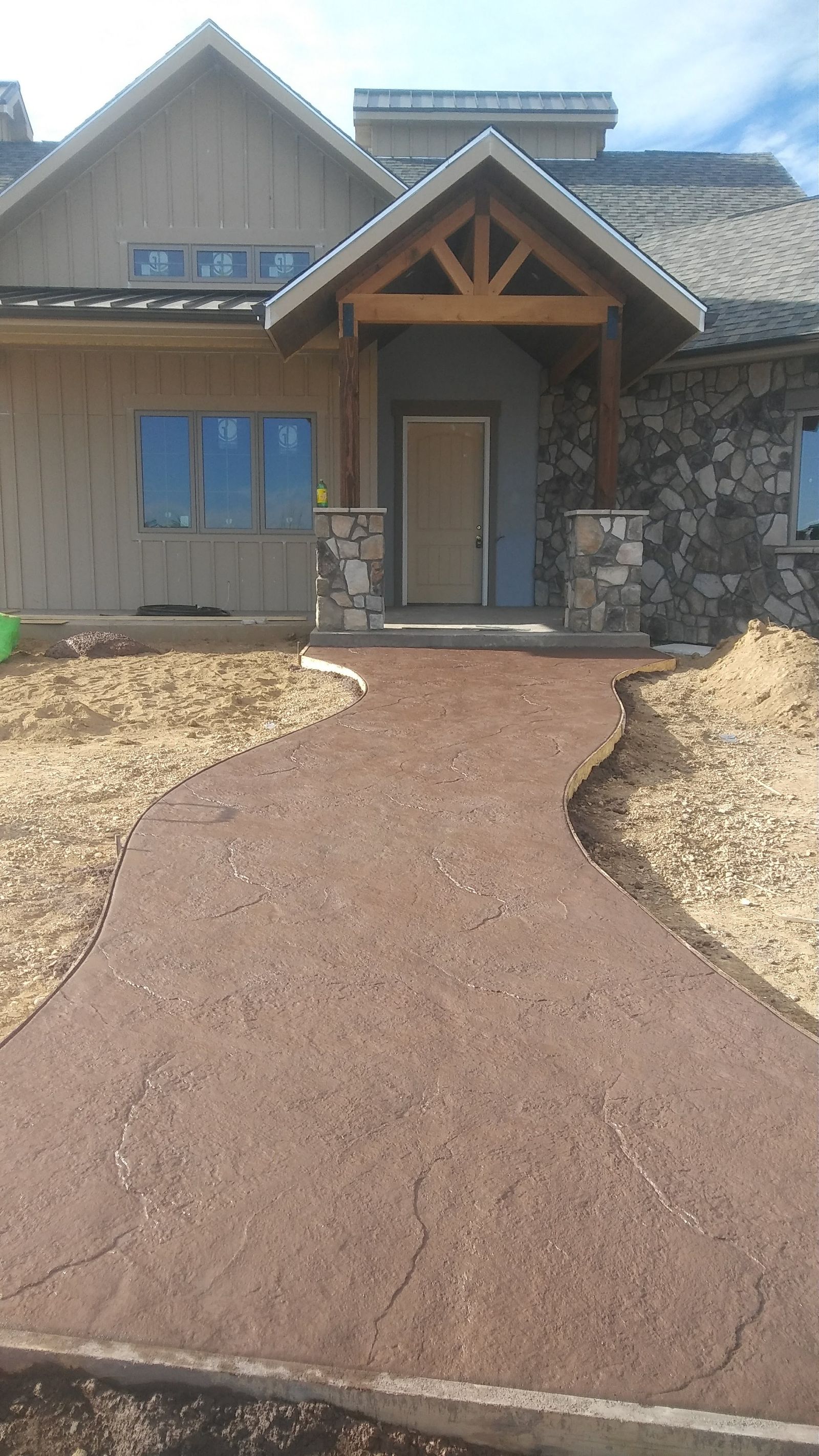 Artisan Rich Earth-Tone Stamped Slate Curved Walkway Leading to Craftsman Entryway by Happy's Concrete