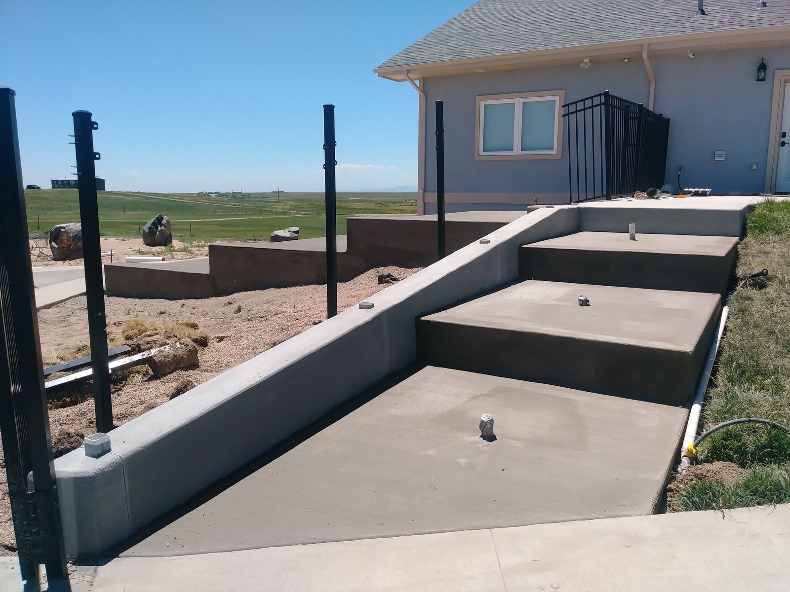 Tiered Retaining Wall Steps with Integrated Conduit Sockets