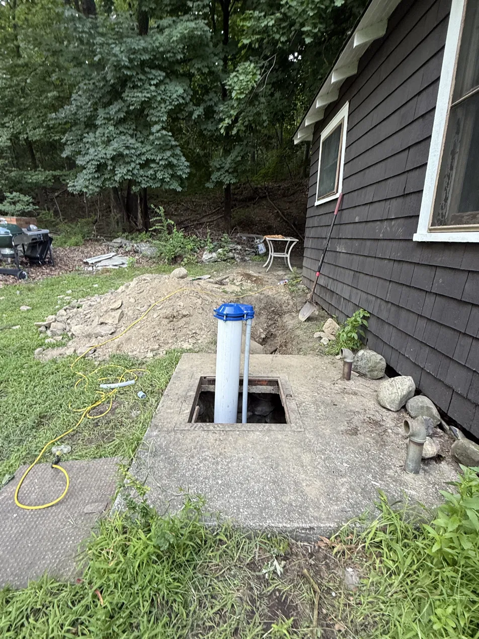 Well casing raised above grade with a new sanitary well cap to meet New Jersey code — Sunrise Pump & Well Water Service
