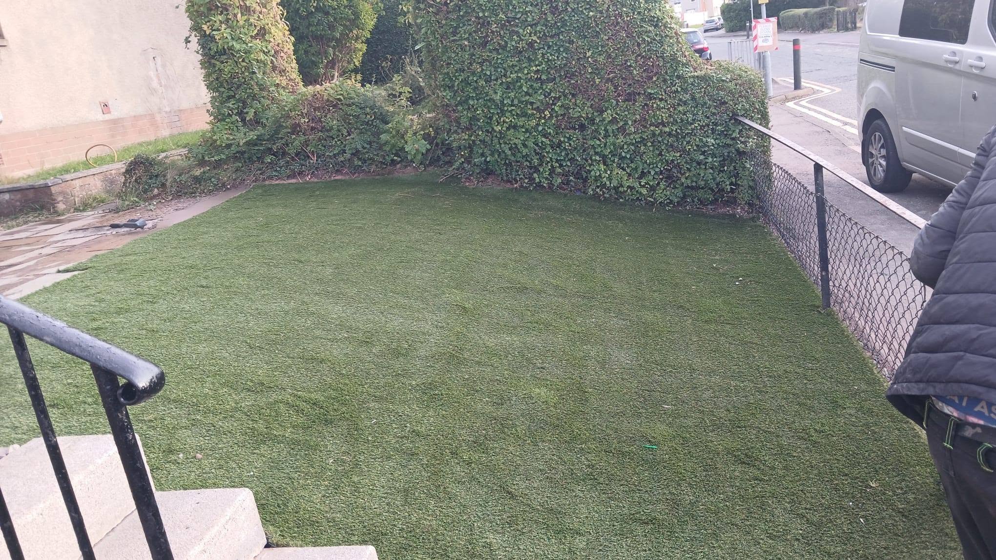 Completed lush green artificial grass lawn installation by Clear Stone