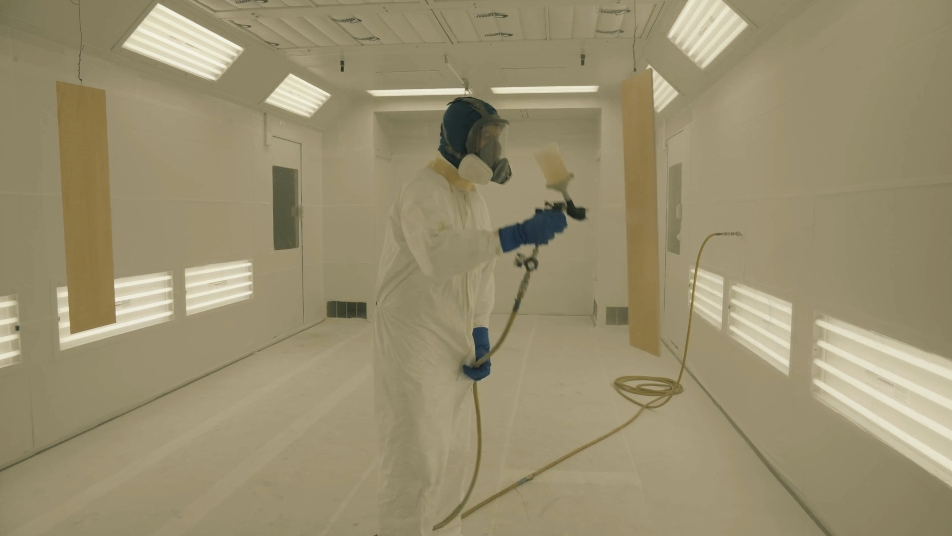 Enclosed spray booth interior for climate-controlled finishes