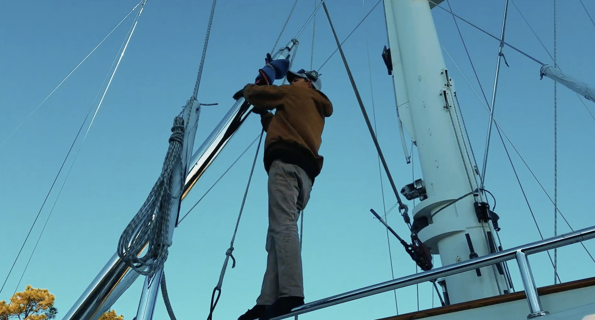 Rigger inspecting standing rigging and masthead hardware