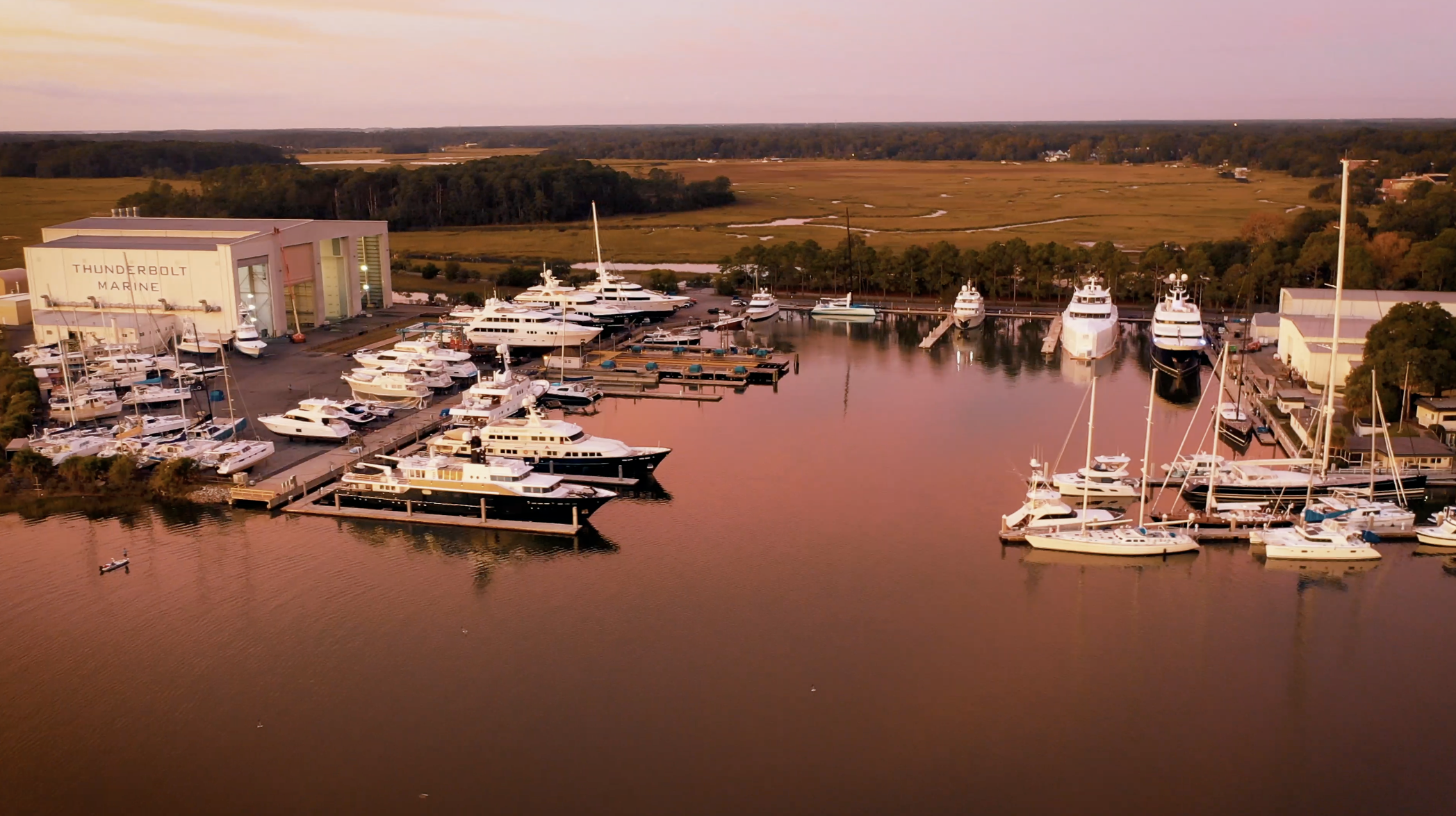 Thunderbolt Marine waterfront service yard and marina basin at golden hour near Savannah GA