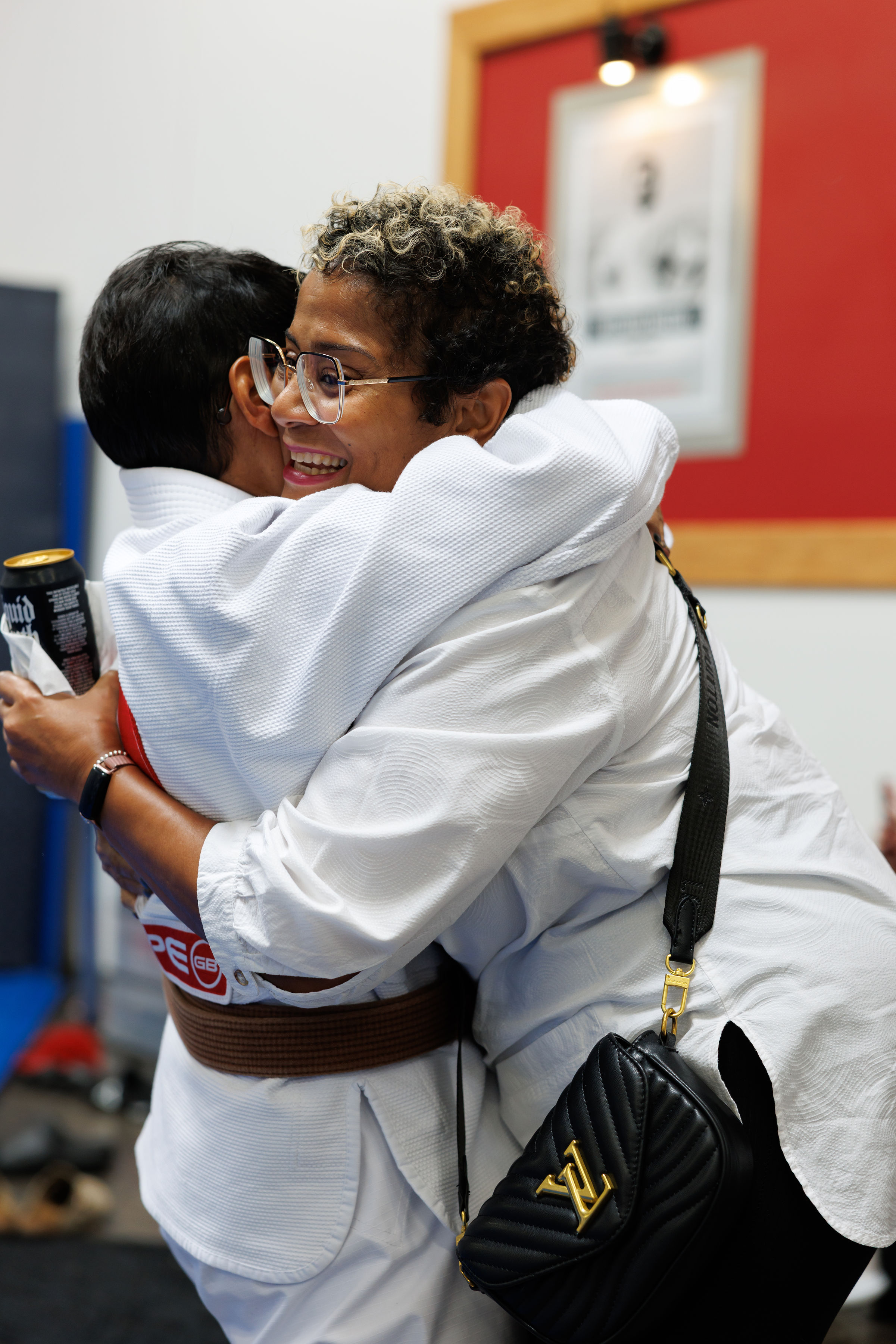 Family member hugging a student after a belt milestone at Gracie Barra Scottsdale