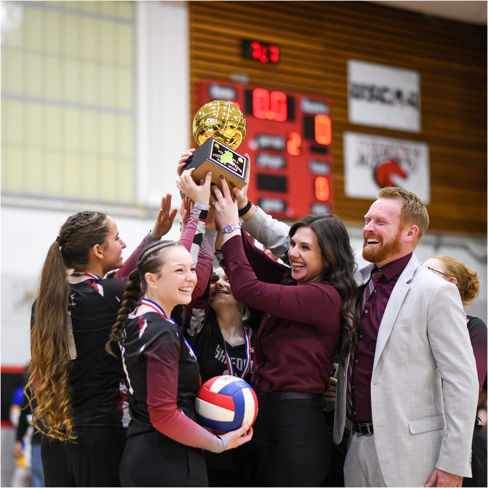 SCA Volleyball Championship Trophy Hoist with Coaches