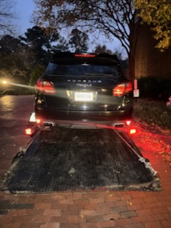 Flatbed rollback towing a Porsche in McDonough, GA