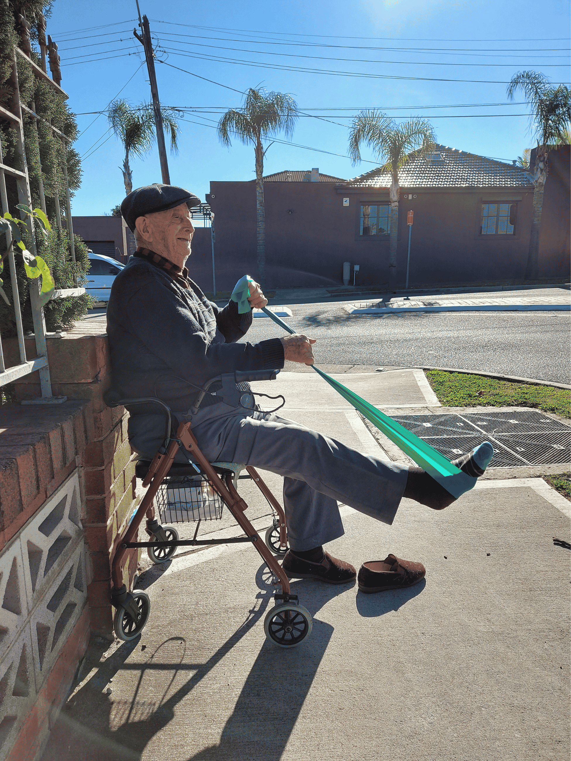 Photo: an older client doing resistance exercises outdoors with walker