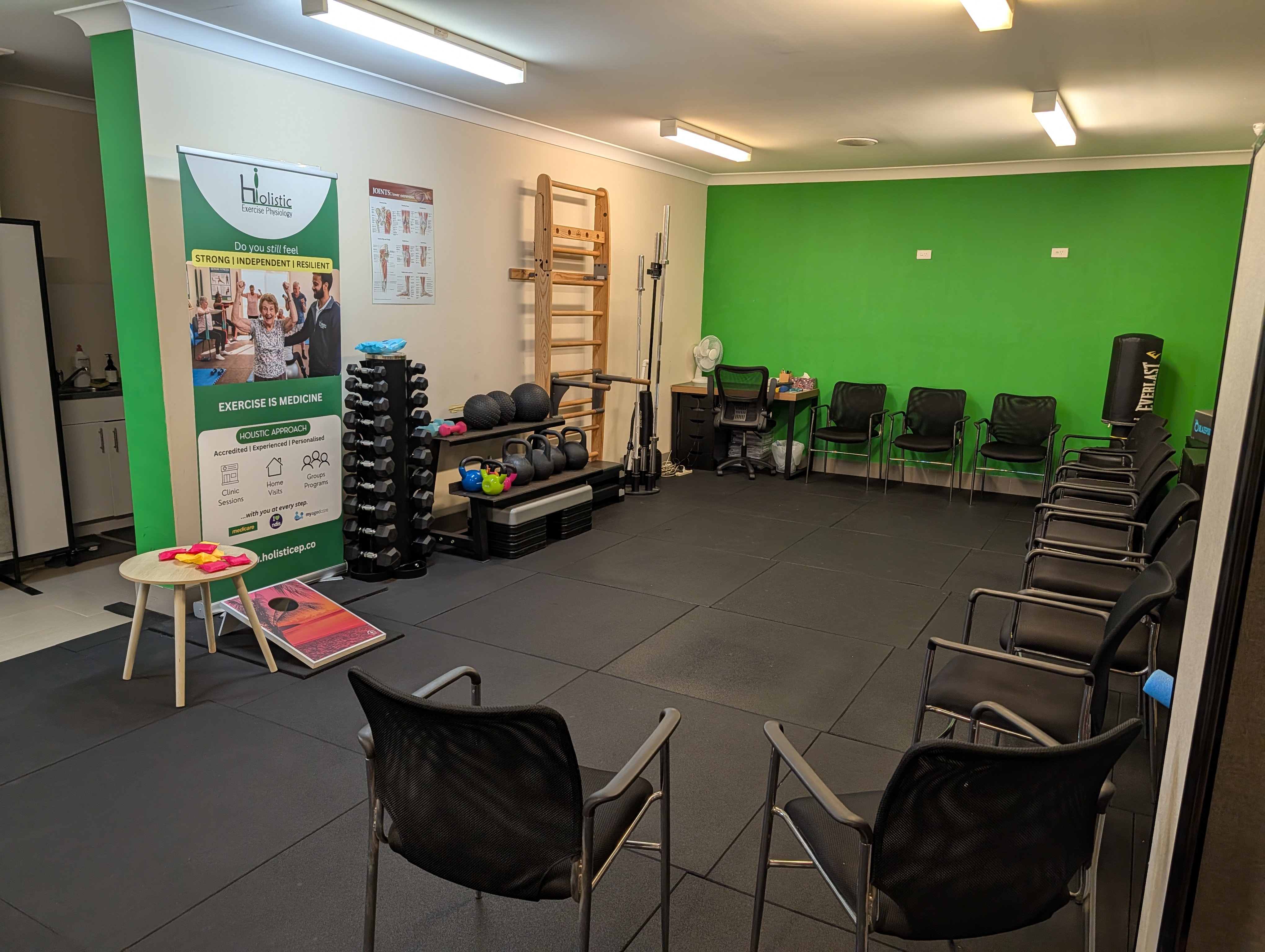 A client training with battle ropes at the Holistic Exercise Physiology clinic in Wentworthville