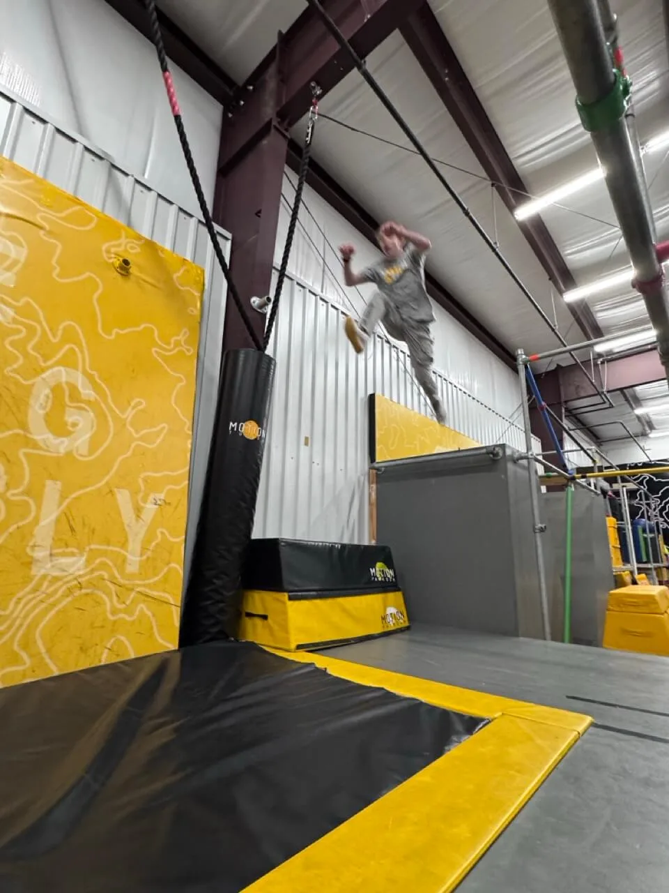 Athlete jumping at a movement-based training facility, showcasing the active communities New Member Ninja helps grow