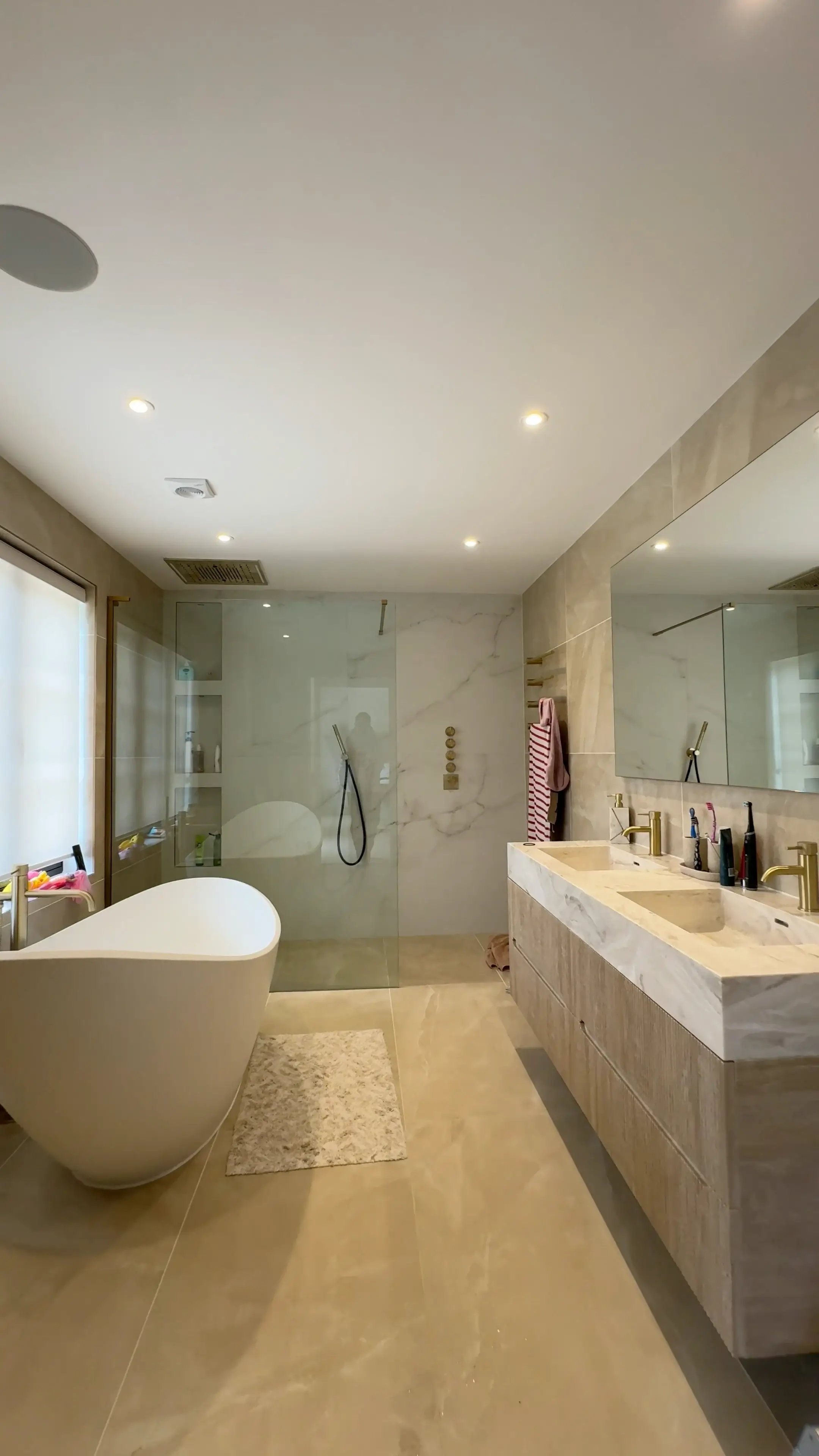 Renovated bathroom with freestanding tub, walk in shower and marble vanity