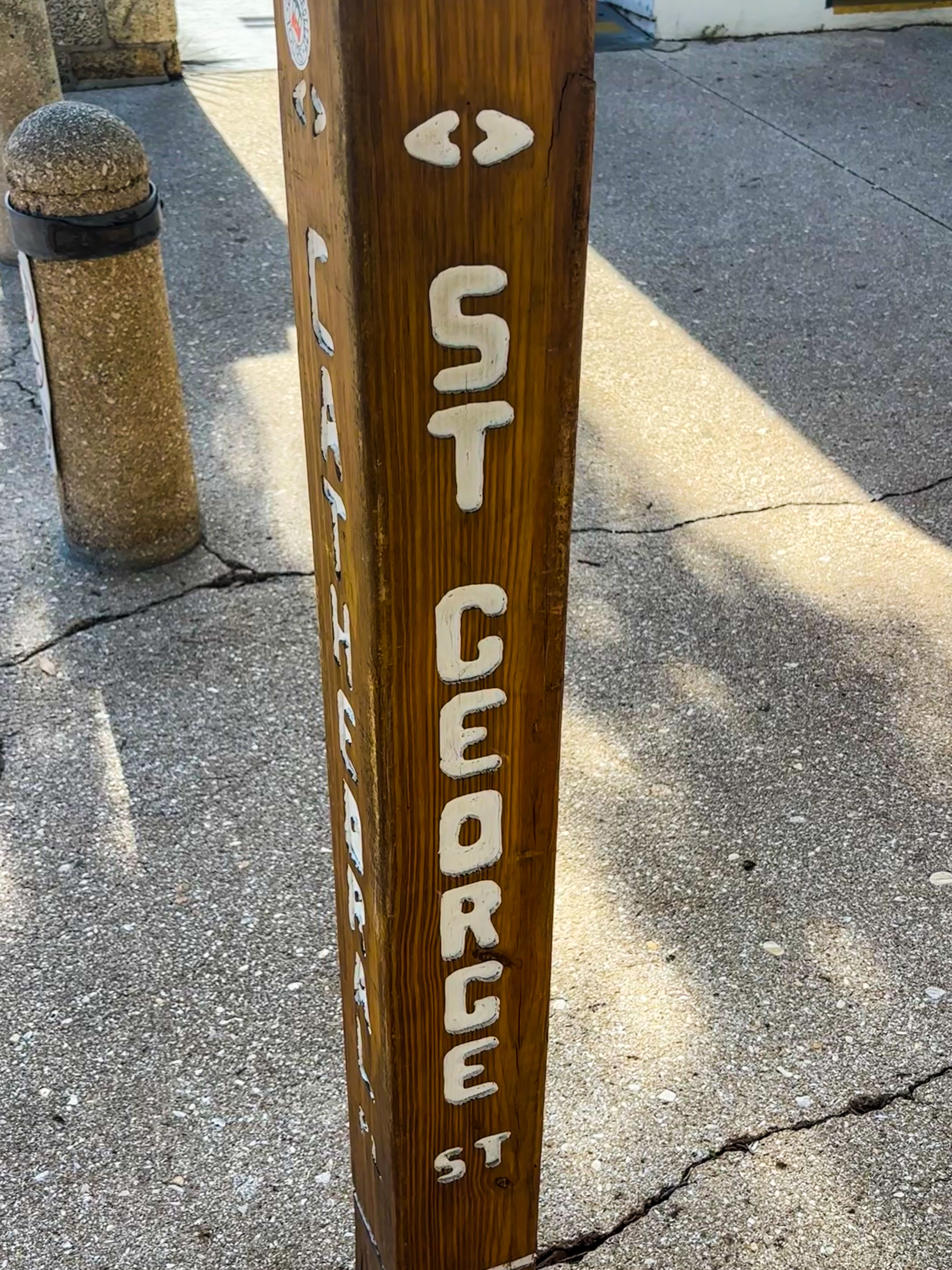 Carved wooden historic marker for St. George Street and Cathedral Place