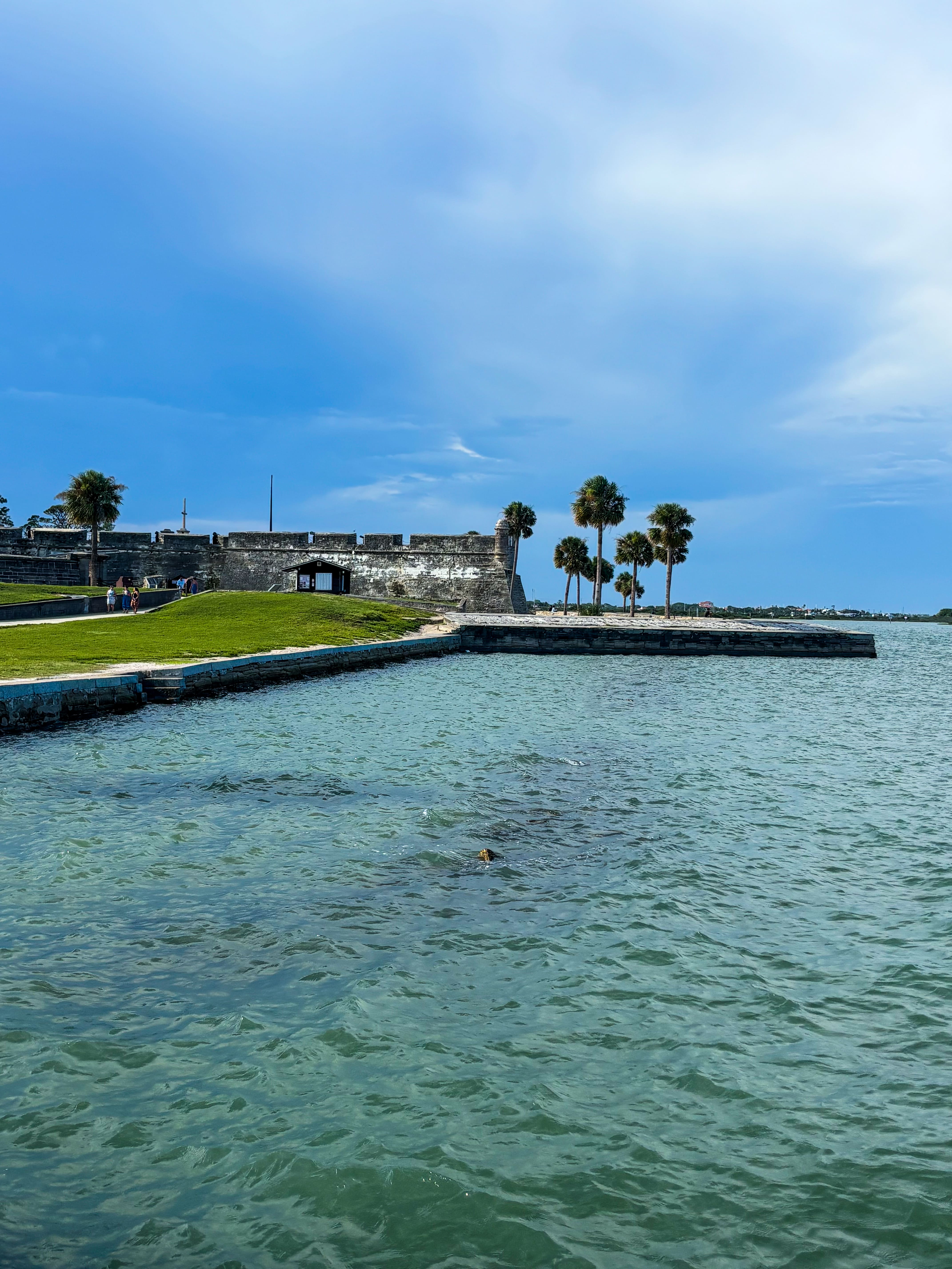 Historic Castillo de San Marcos fort walls along the green-blue waters of Matanzas Bay