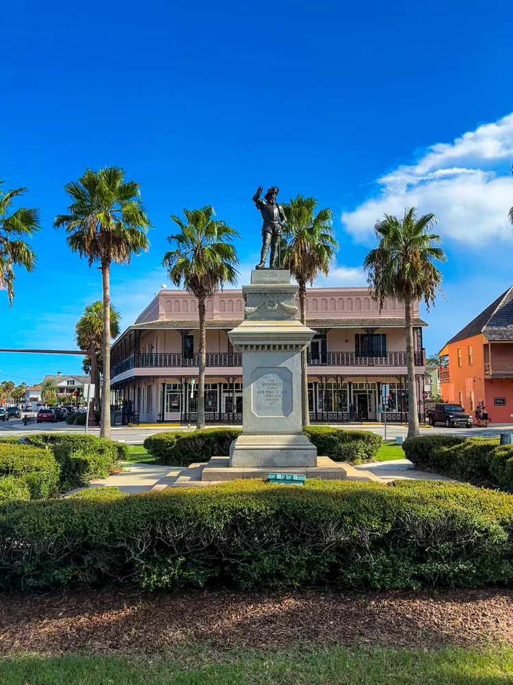 Juan Ponce de Leon bronze monument and palm trees in historic St. Augustine