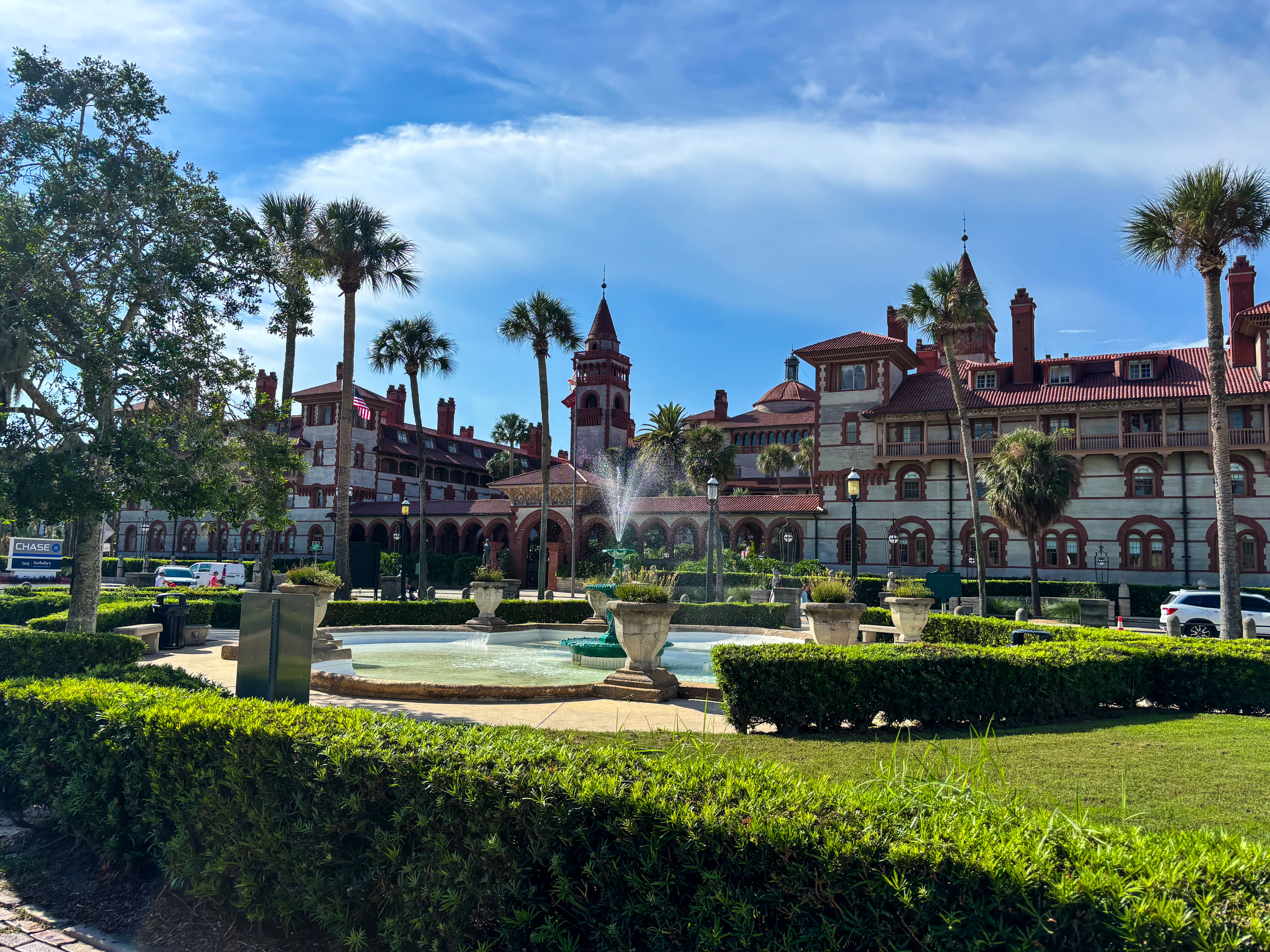 Courtyard fountain and Spanish Renaissance architecture framed by palm trees in St. Augustine