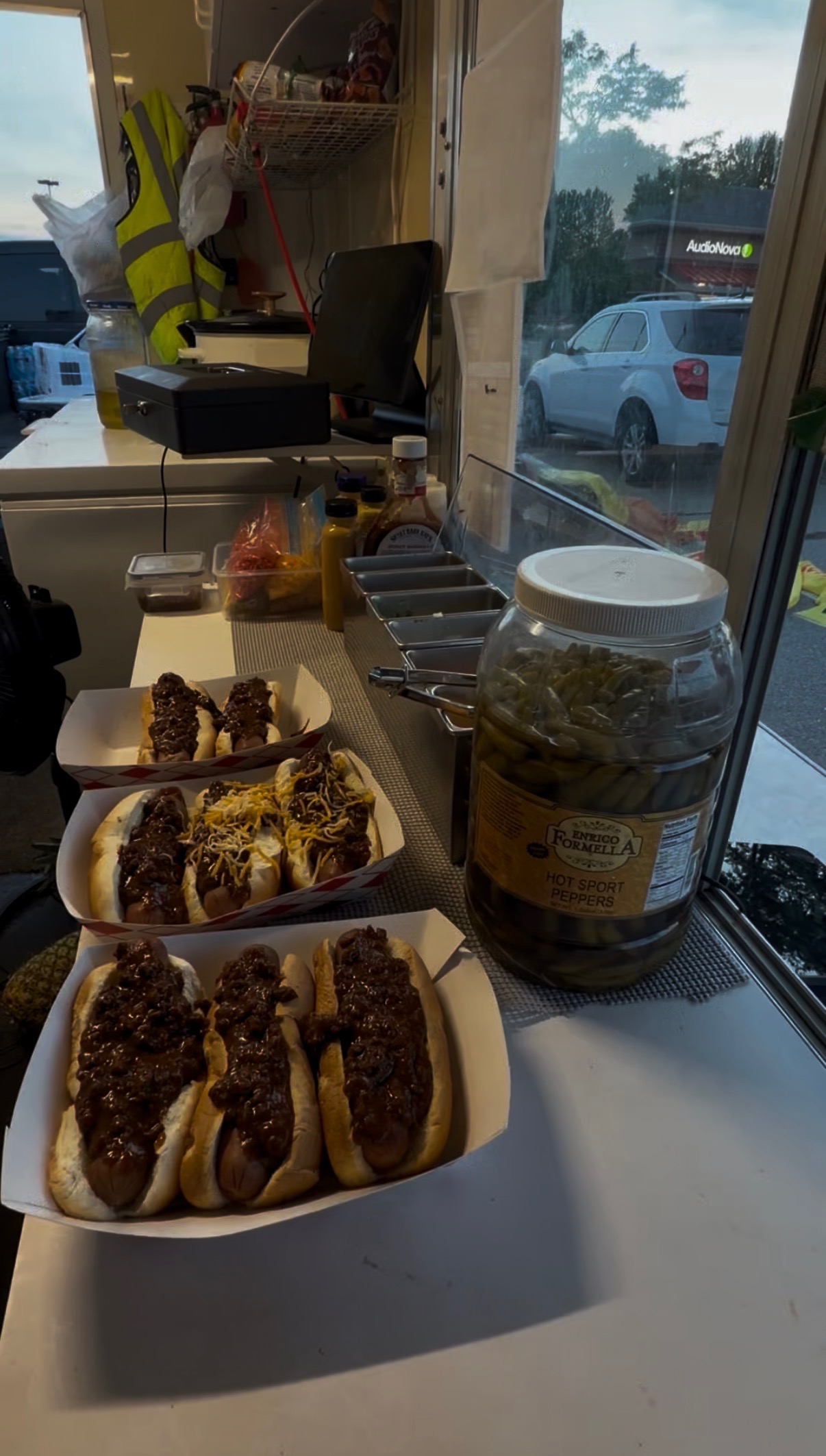 Trays of chili cheese dogs lined up in the Papa Dogs trailer window
