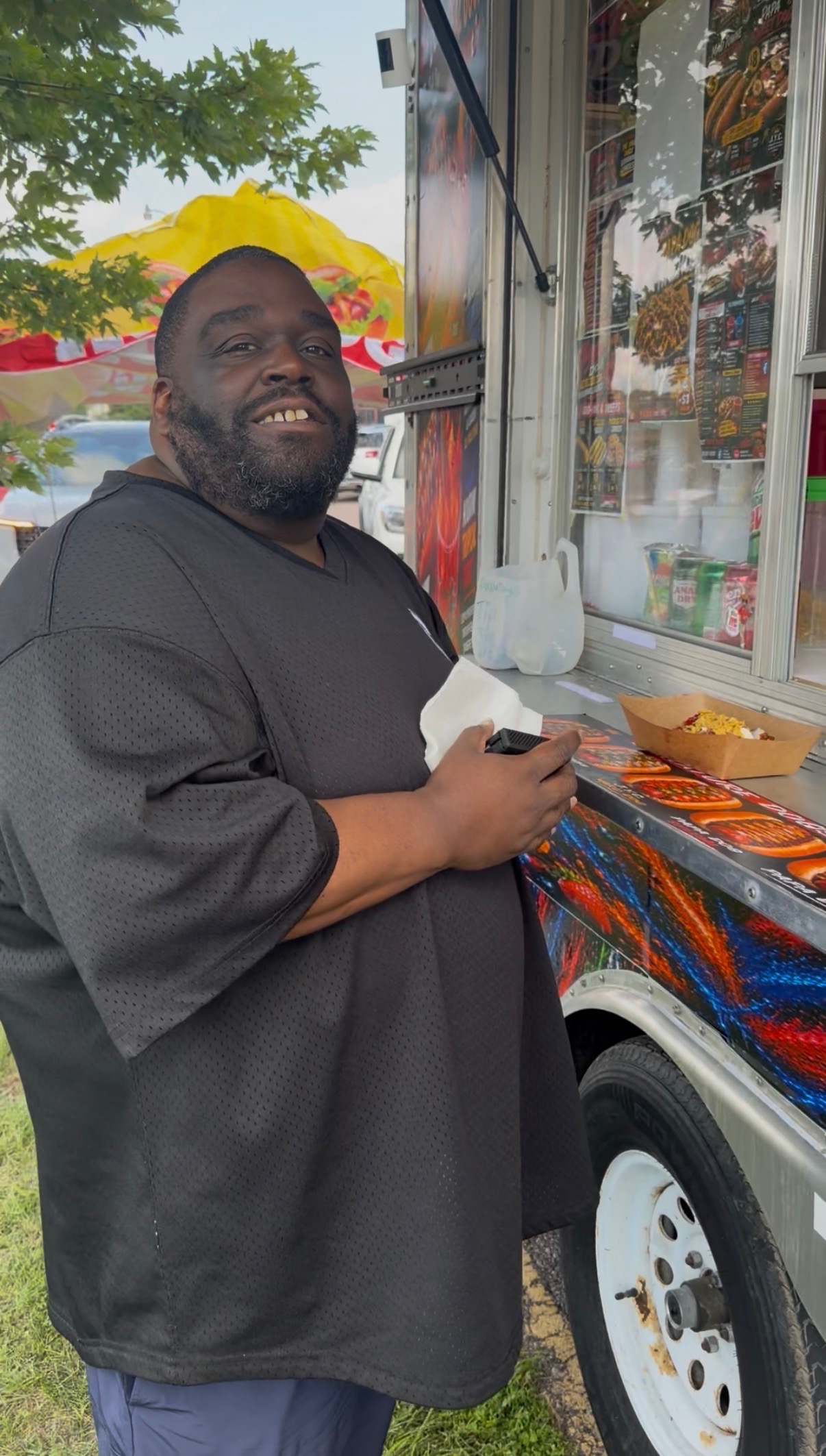 Customer smiling next to the Papa Dogs trailer window