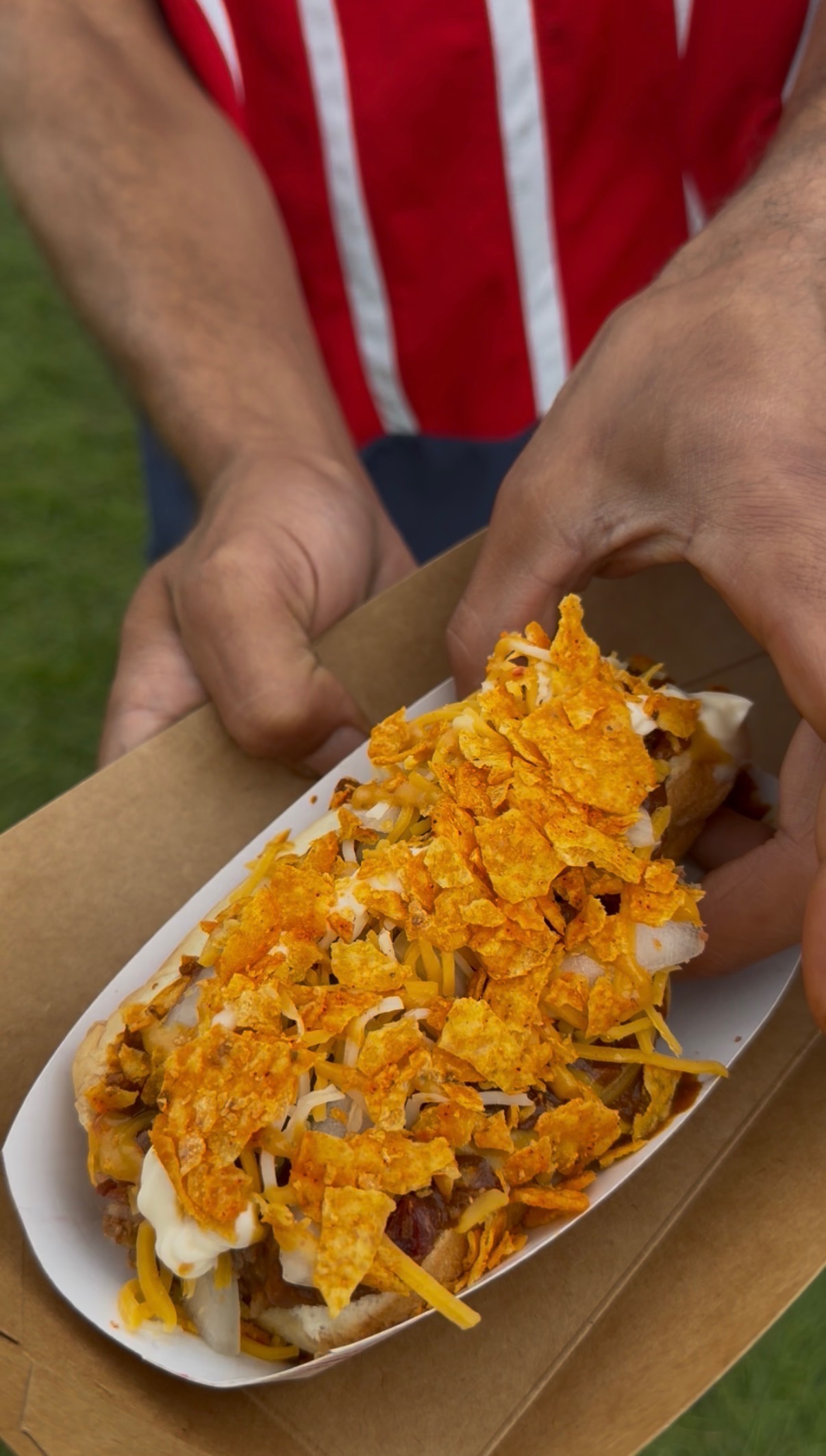 Papa Dogs signature loaded dog topped with crushed chips and cheese