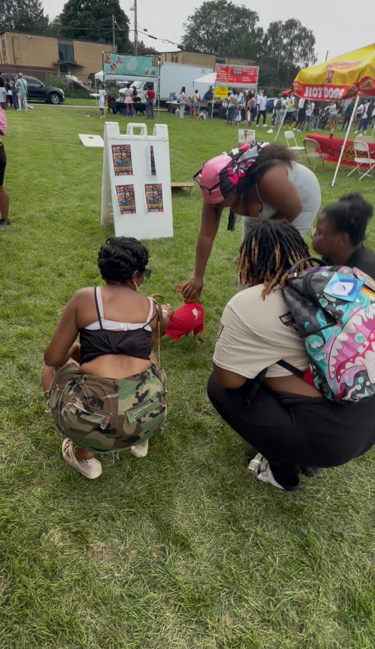 Group of customers with a dog in a Papa Dogs shirt at a community event