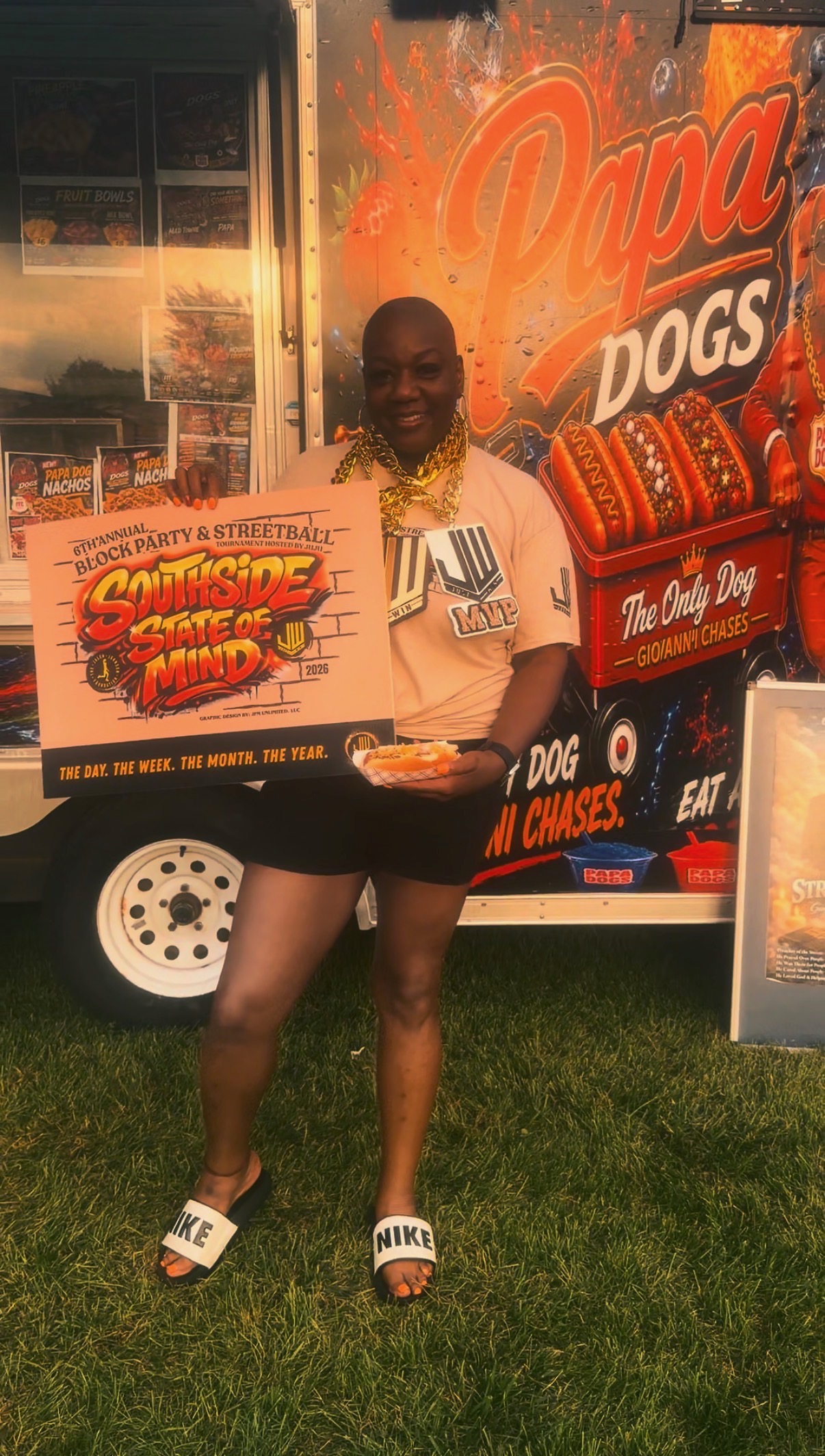 Customer holding a Southside State of Mind sign in front of the Papa Dogs trailer