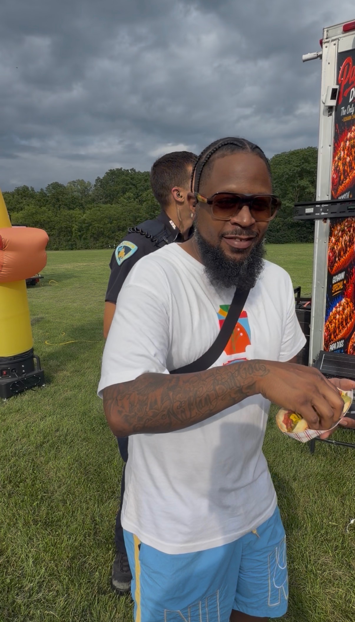Happy customer enjoying a Papa Dogs hot dog outdoors