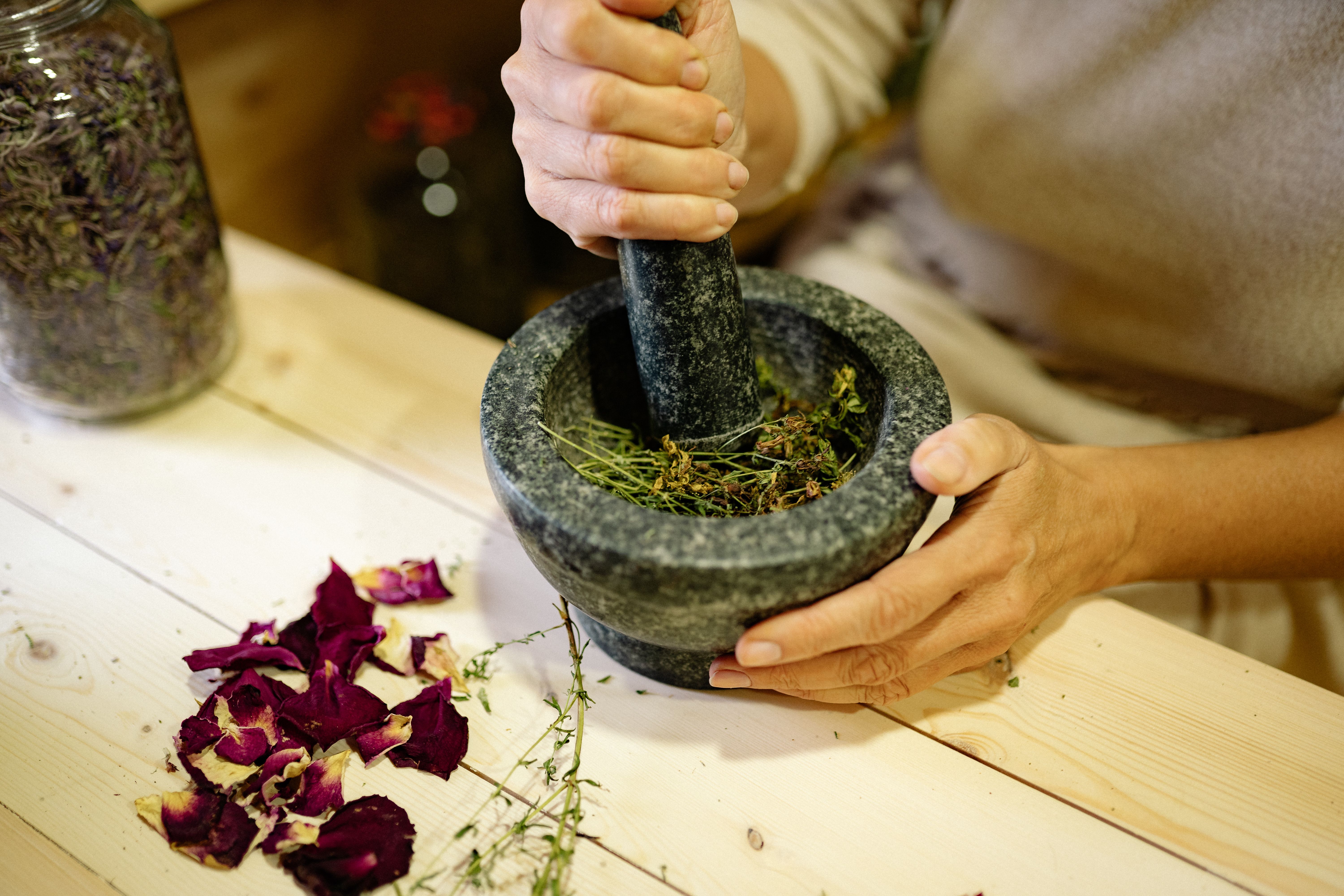 Mortar and pestle grinding medicinal herbs, rooted in centuries of holistic healing tradition