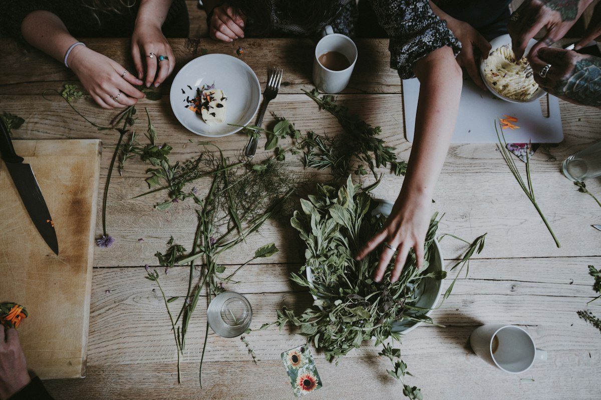 Hand resting on fresh green leaves symbolizing natural healing